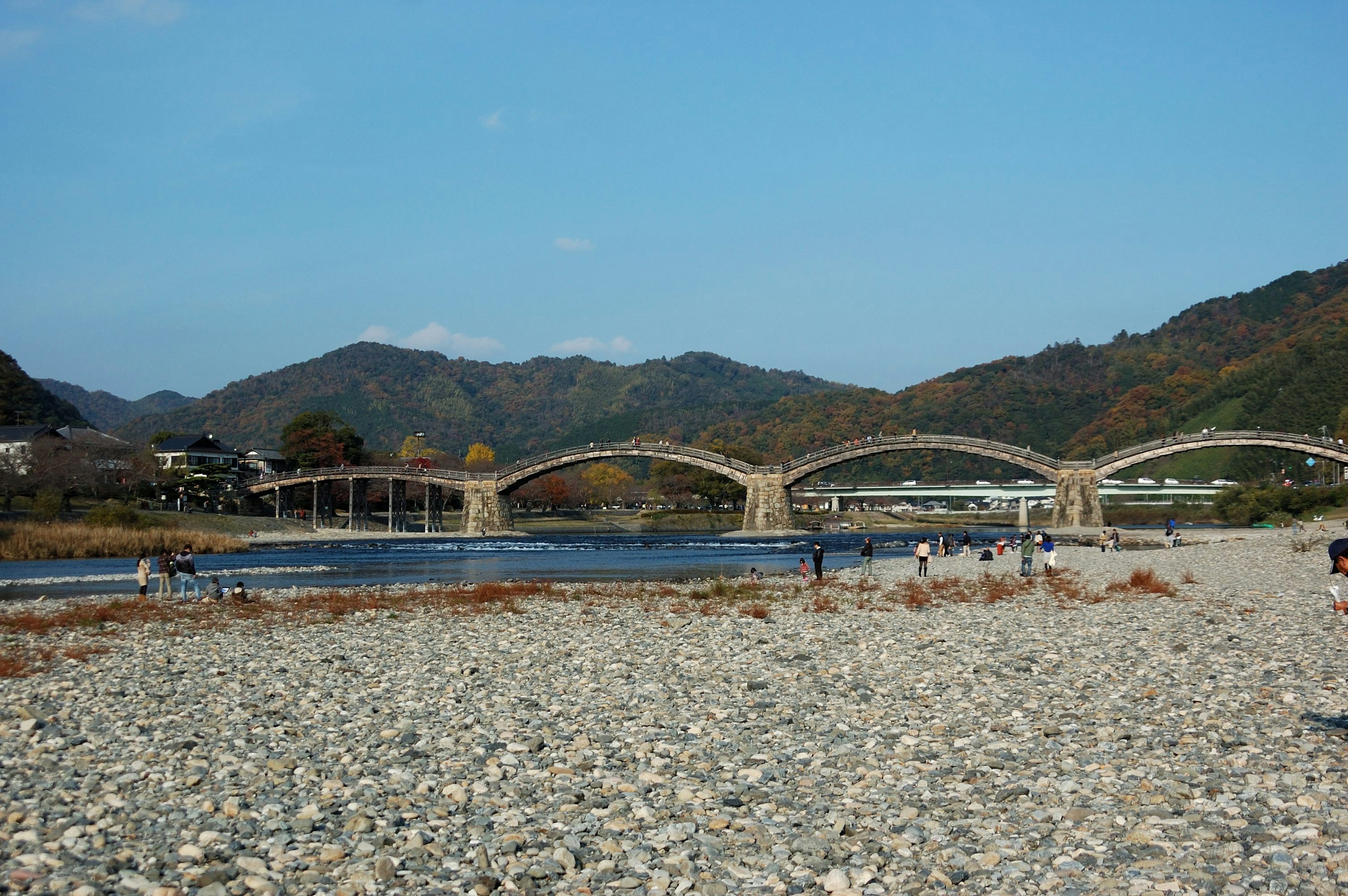 美しい山々を背景にした川とアーチ型の橋