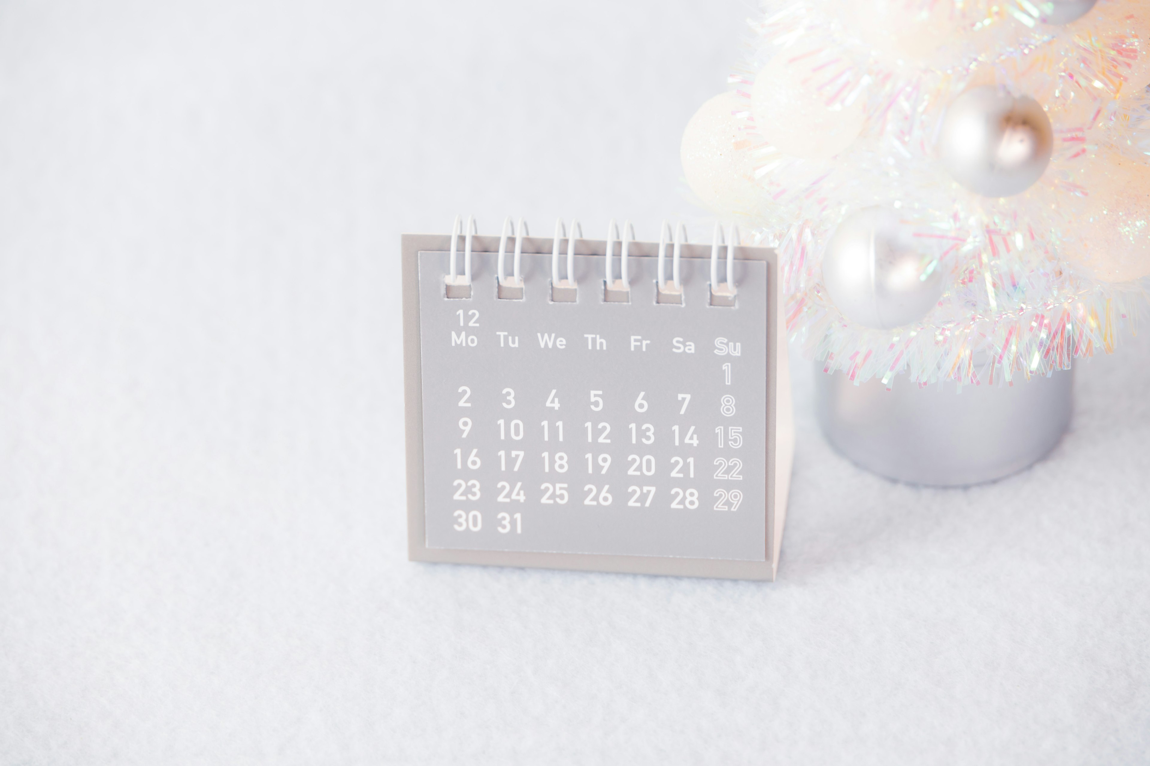 A small calendar placed near a Christmas tree