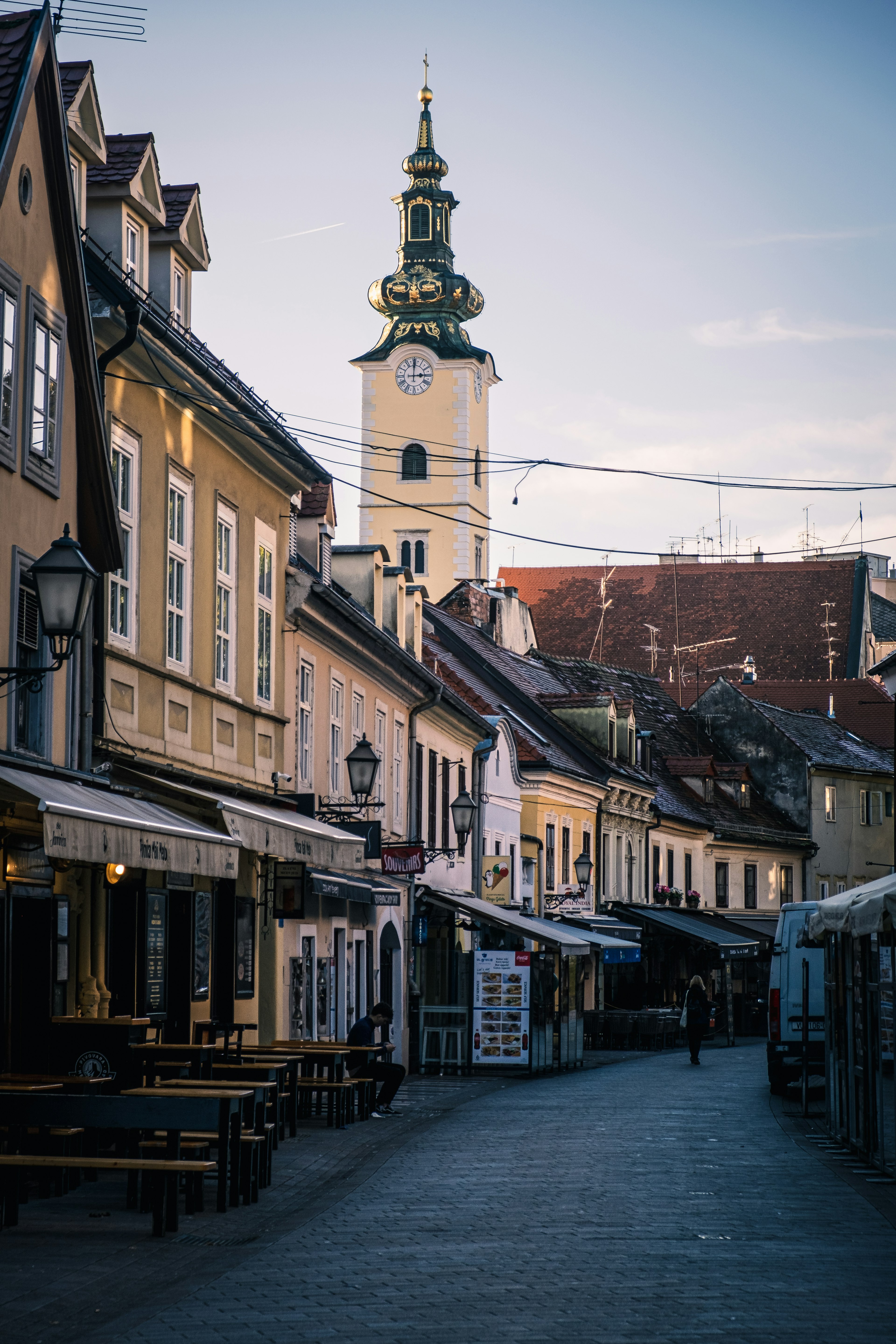 Quiet street featuring charming buildings and a tall clock tower