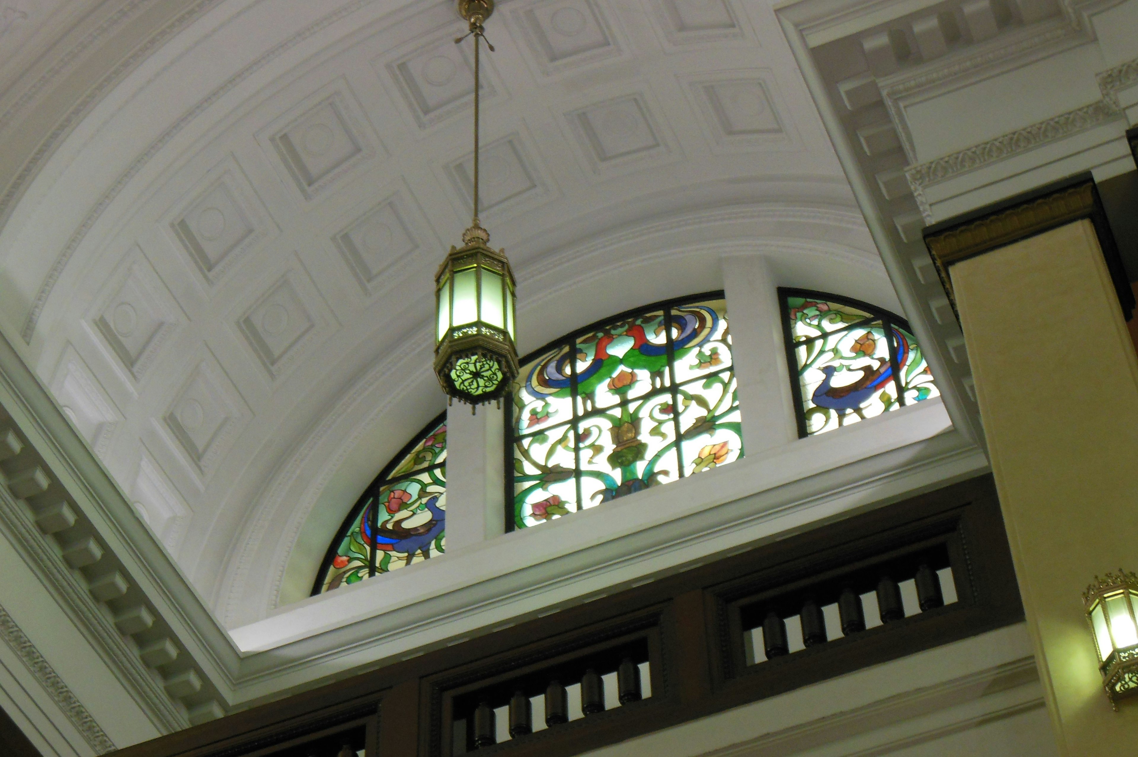 Elegant ceiling with beautiful stained glass windows and decorative lighting