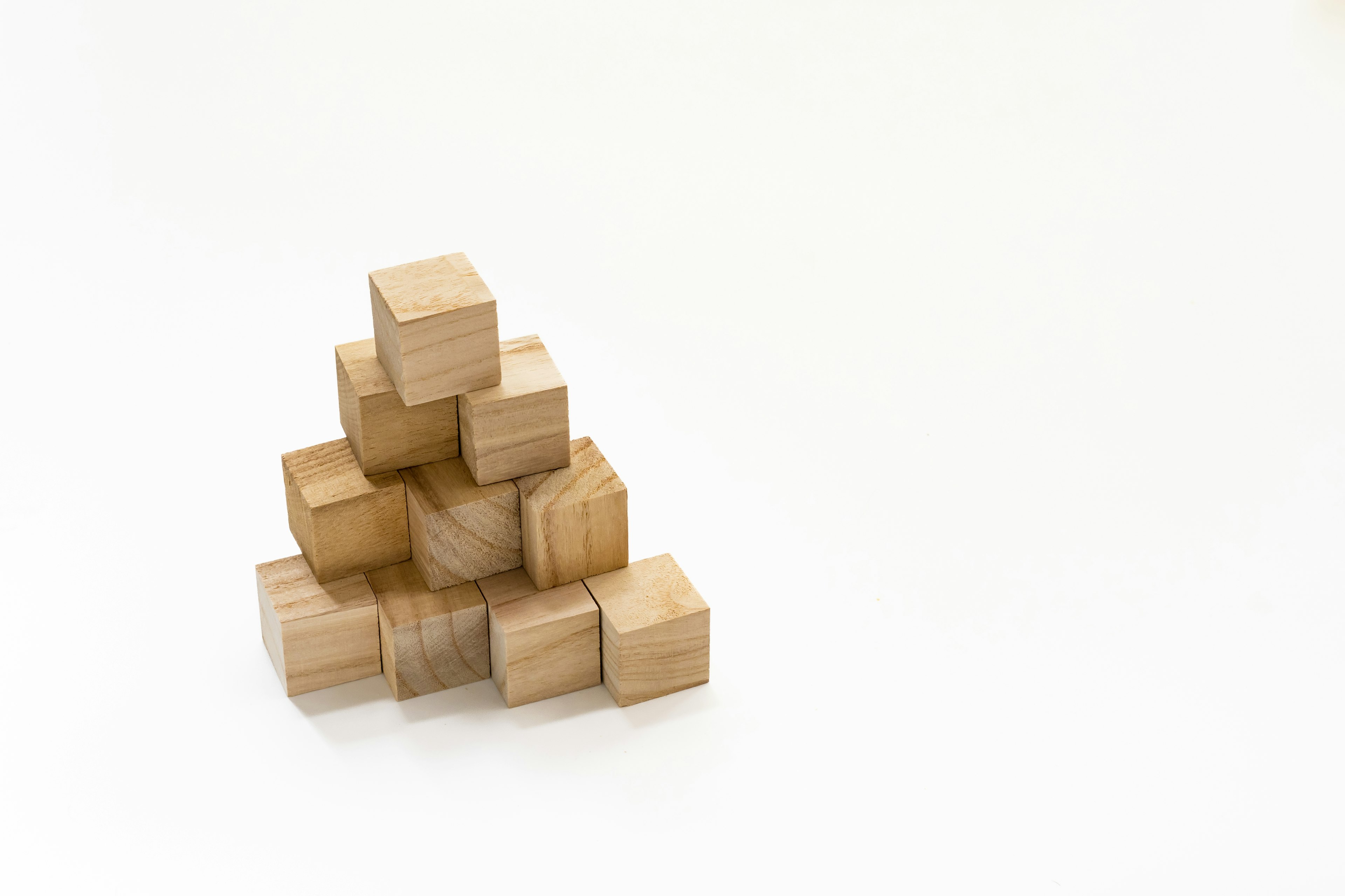 A simple image of wooden blocks stacked in a triangular shape