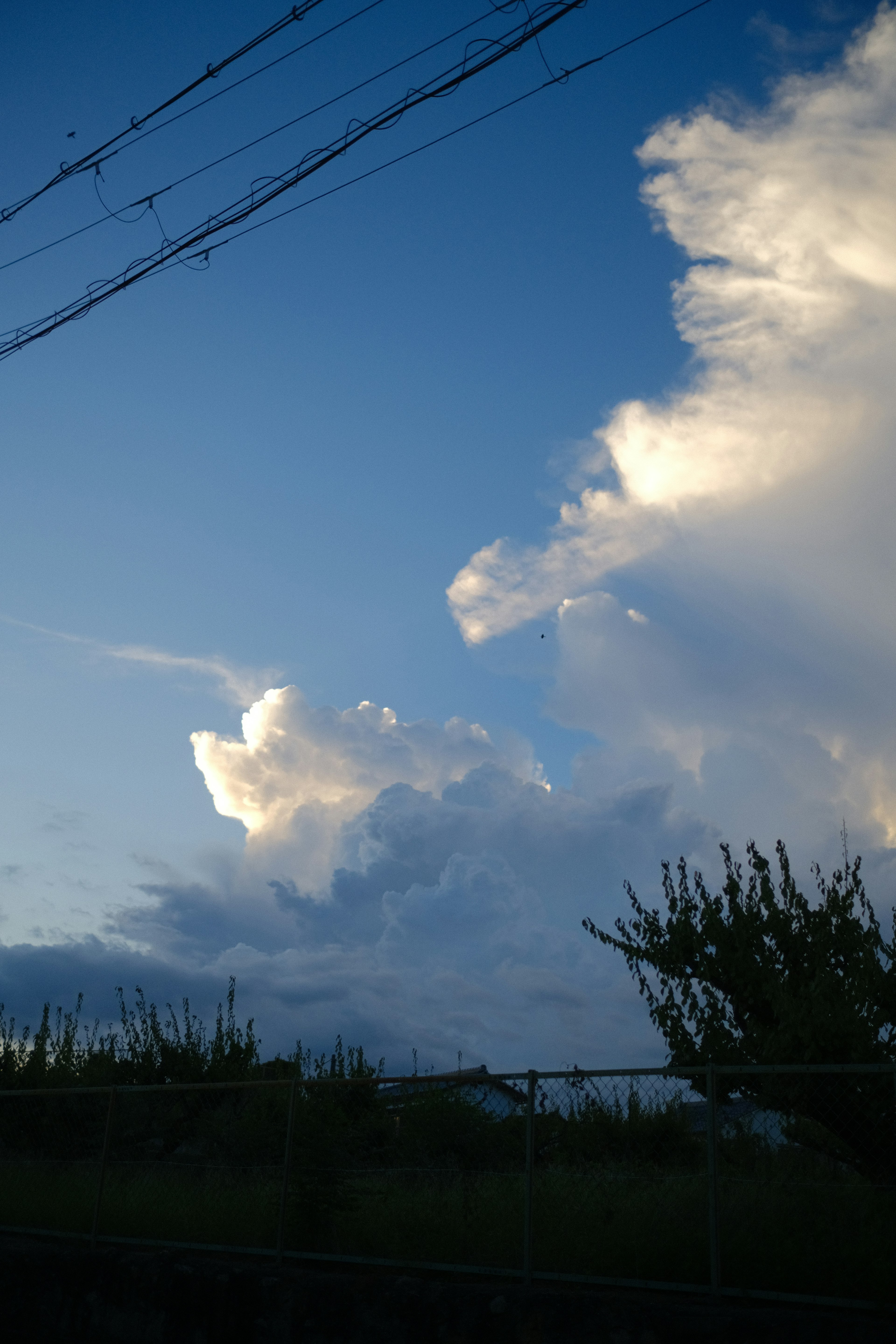 Eine Landschaft mit weißen Wolken vor einem blauen Himmel