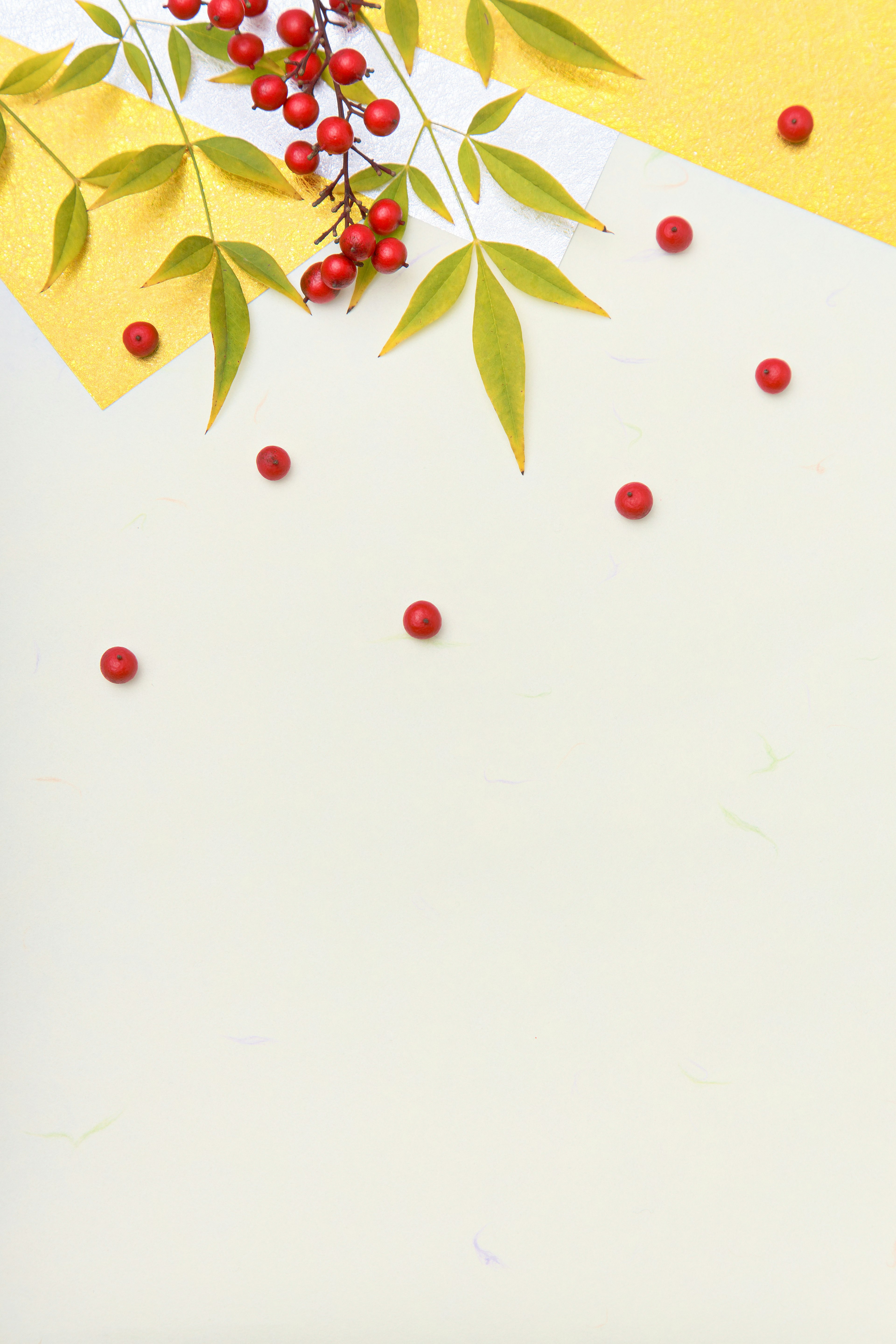 Design featuring red berries and green leaves on a yellow background