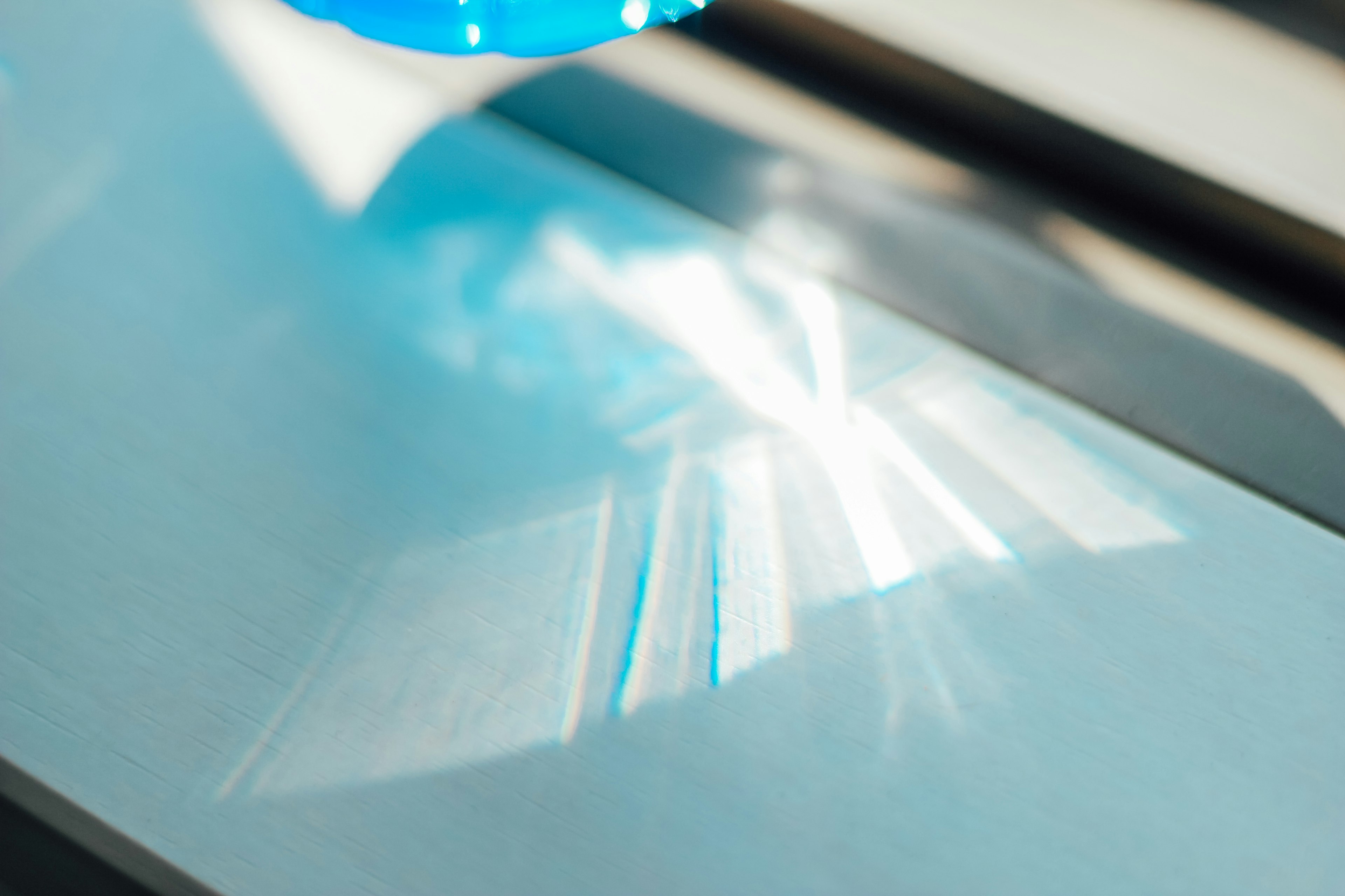 Blue liquid creating a light reflection on a surface