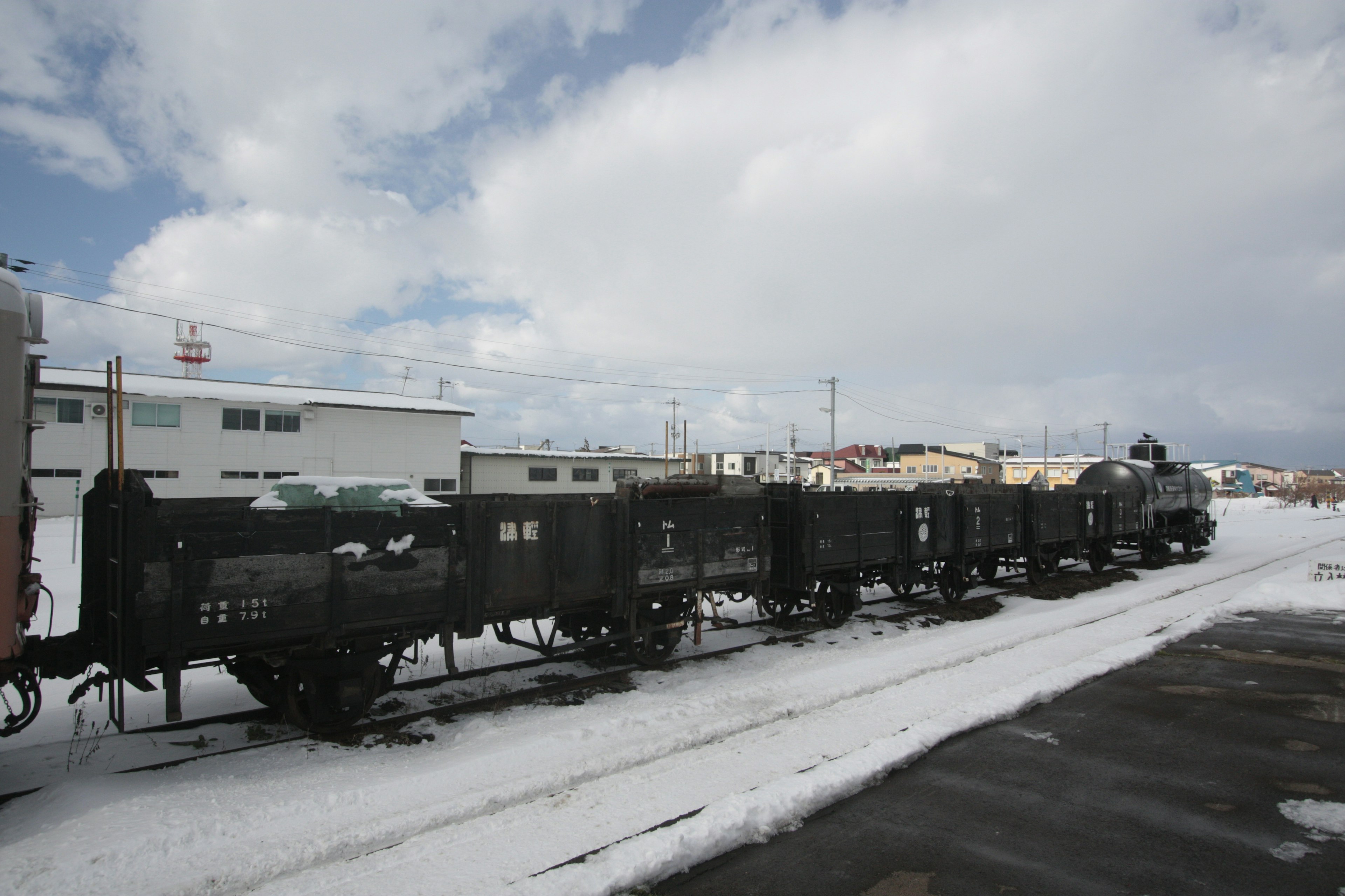 Old train and freight cars lined up in a snowy landscape