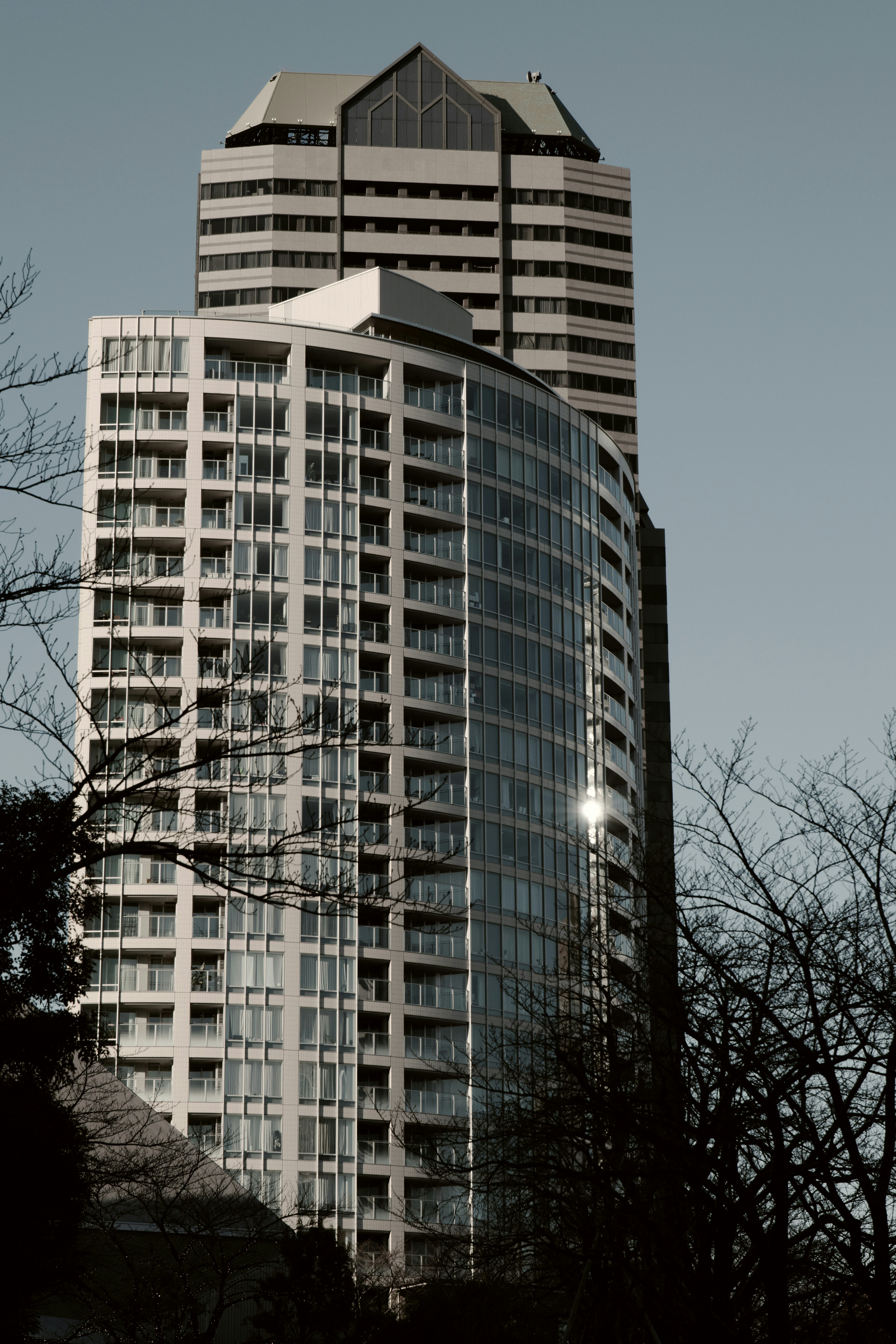 Unique design of a tall building with glass reflections