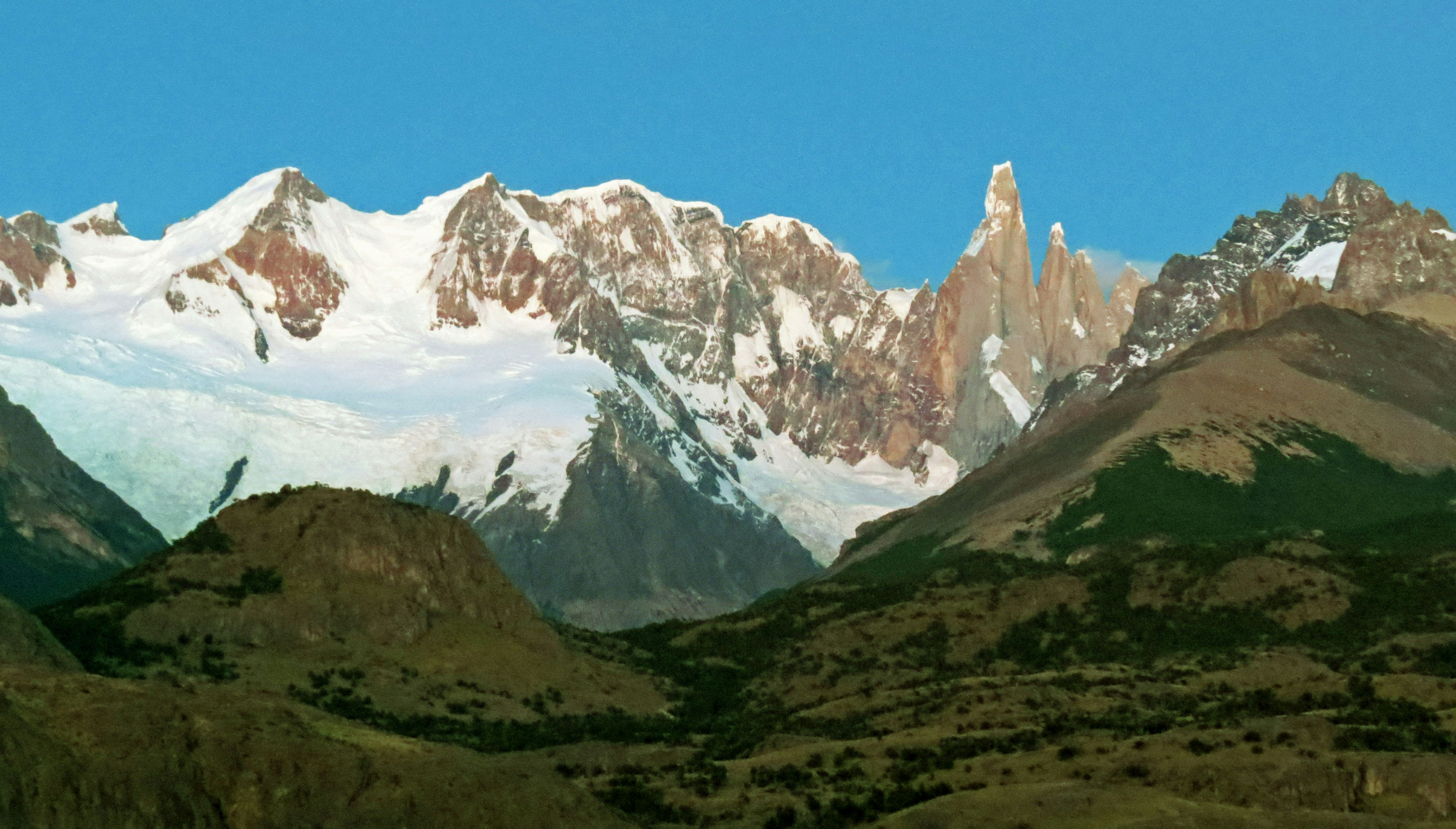 Snow-capped mountains under a clear blue sky