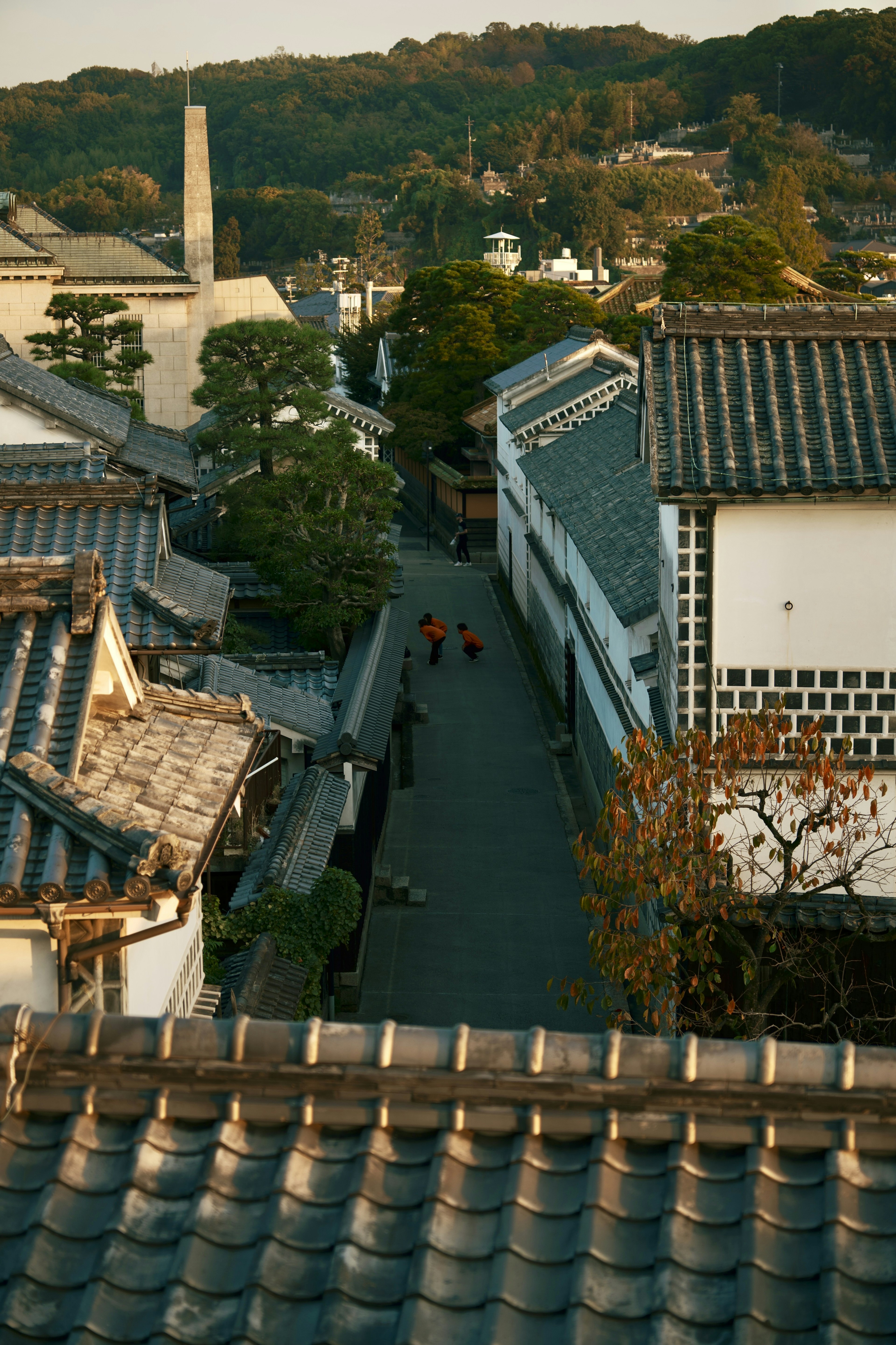 A view of an old Japanese street with people walking along it