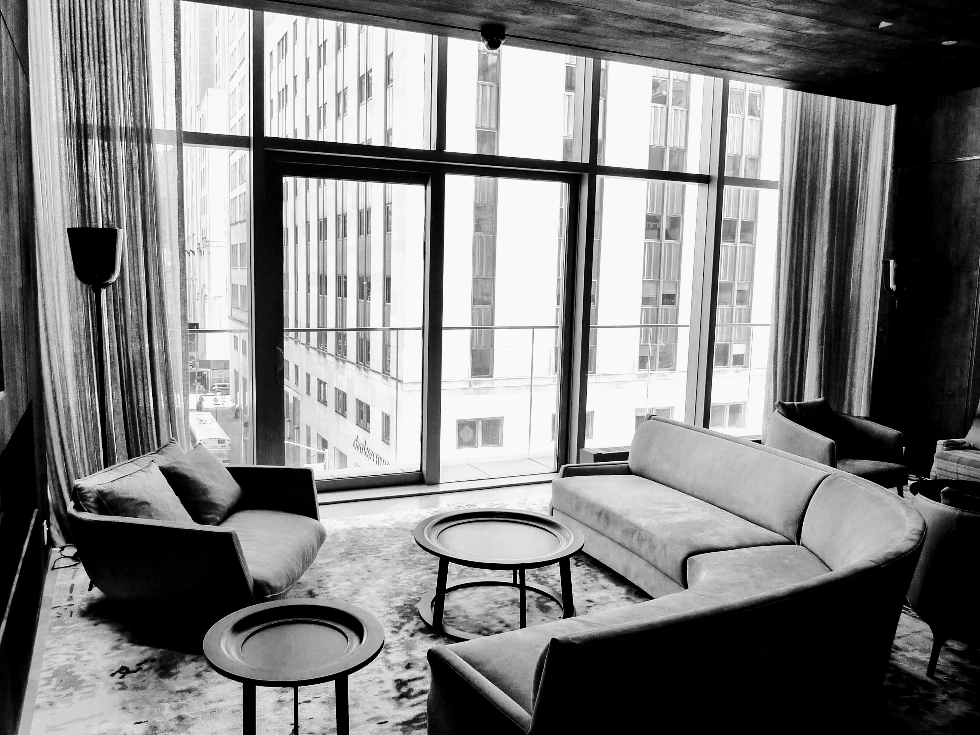 Modern living room interior featuring a black and white sofa and chair large window allowing natural light