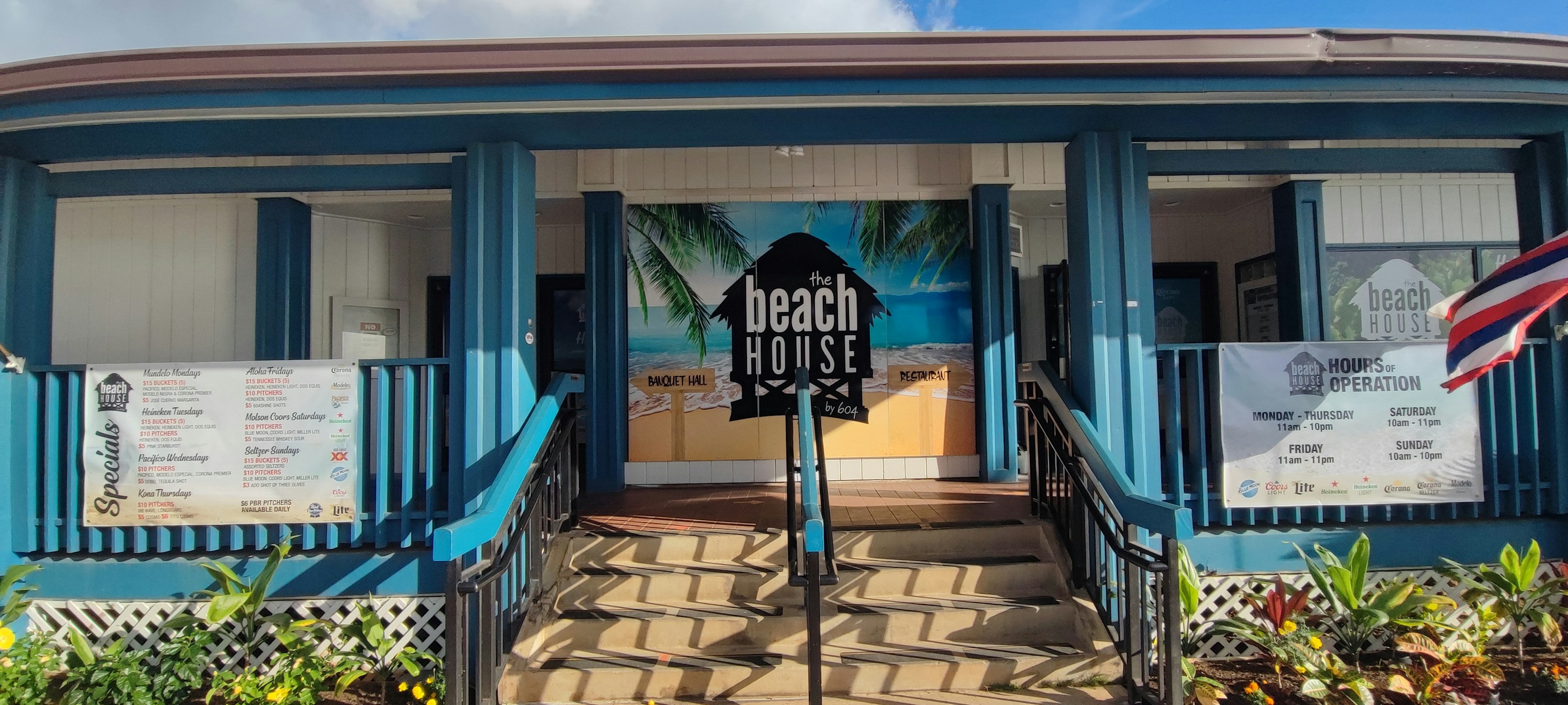 Colorful exterior of a beach house entrance with palm trees