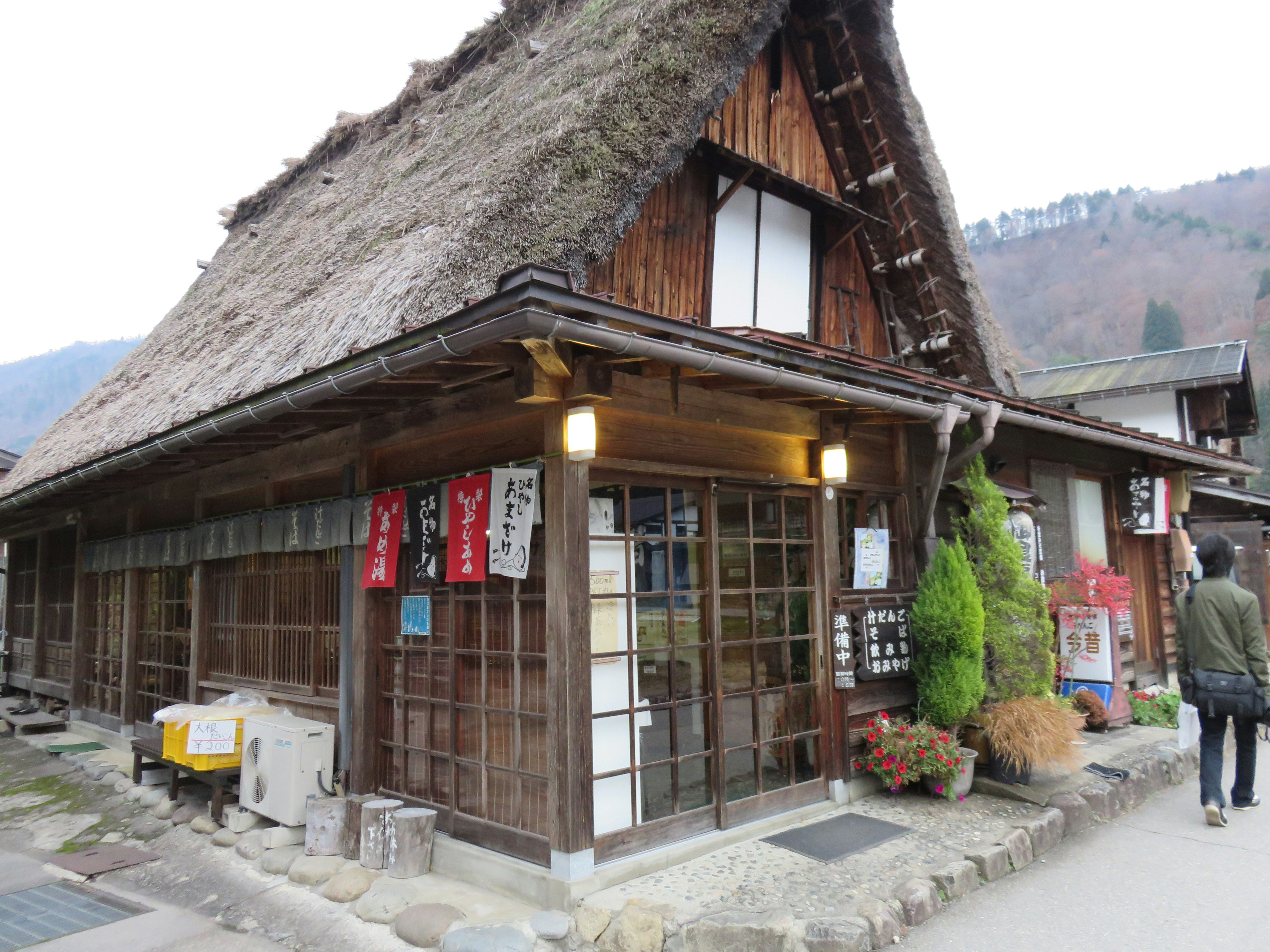 Traditional thatched-roof Japanese house with wooden exterior