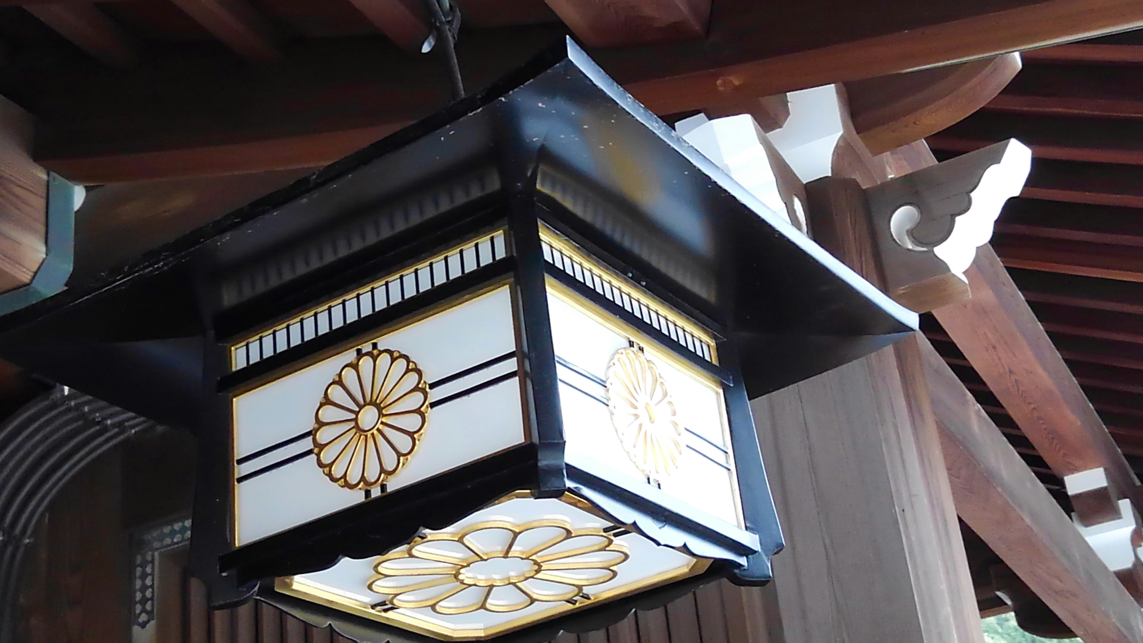 Traditional Japanese lantern hanging from a wooden ceiling