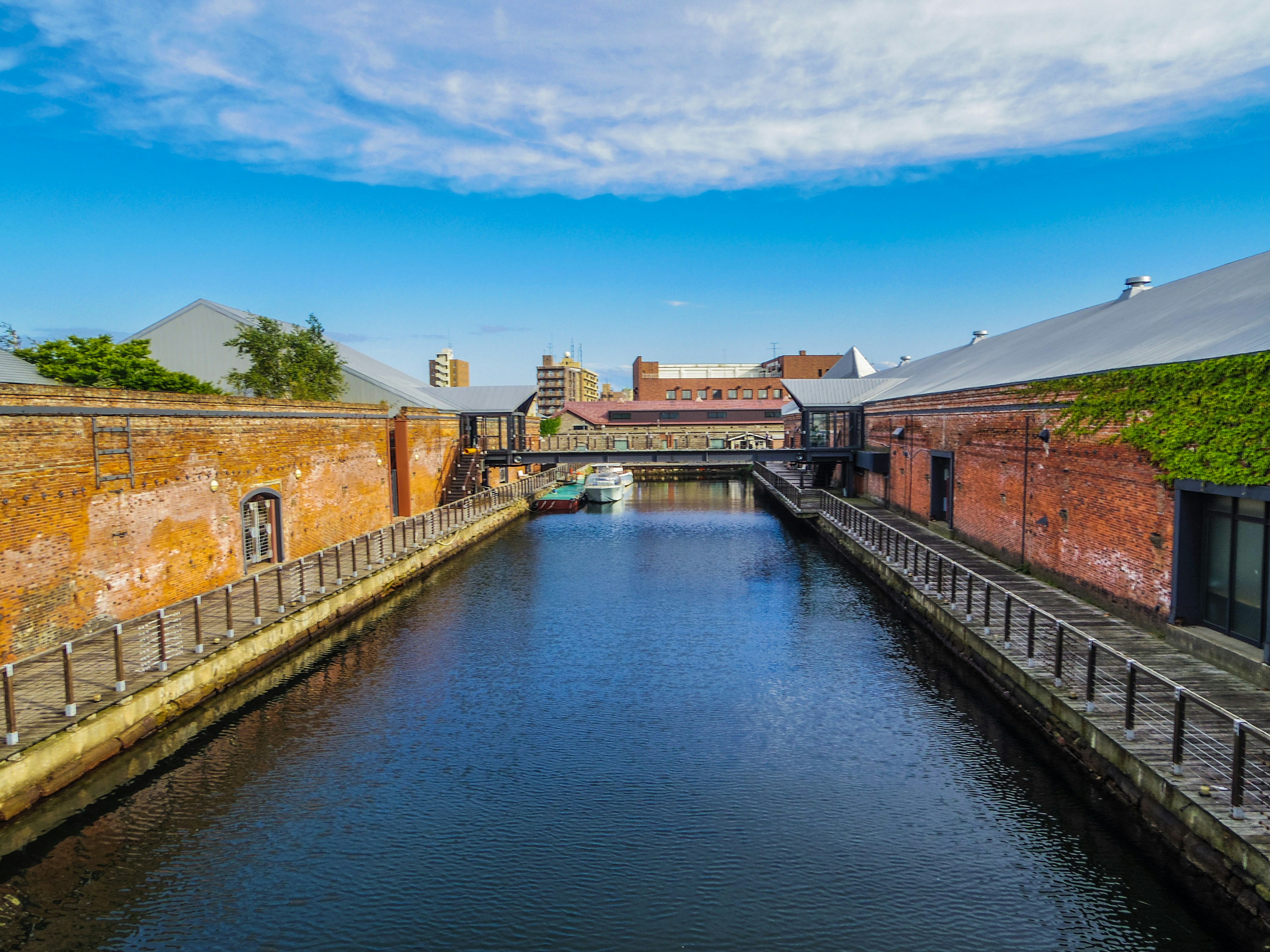 Landscape of red brick buildings and a calm waterway