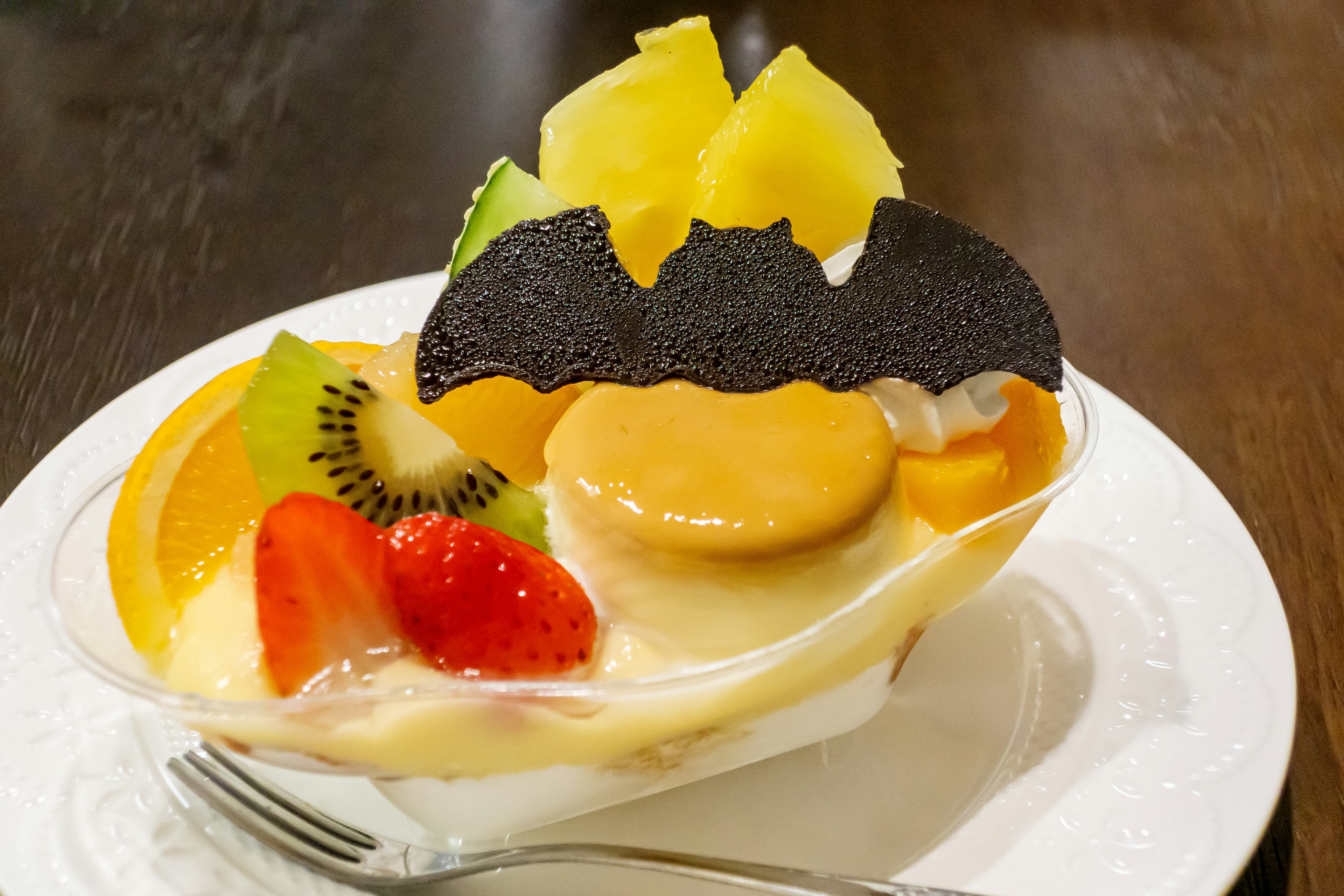 Fruit dessert topped with bat-shaped chocolate