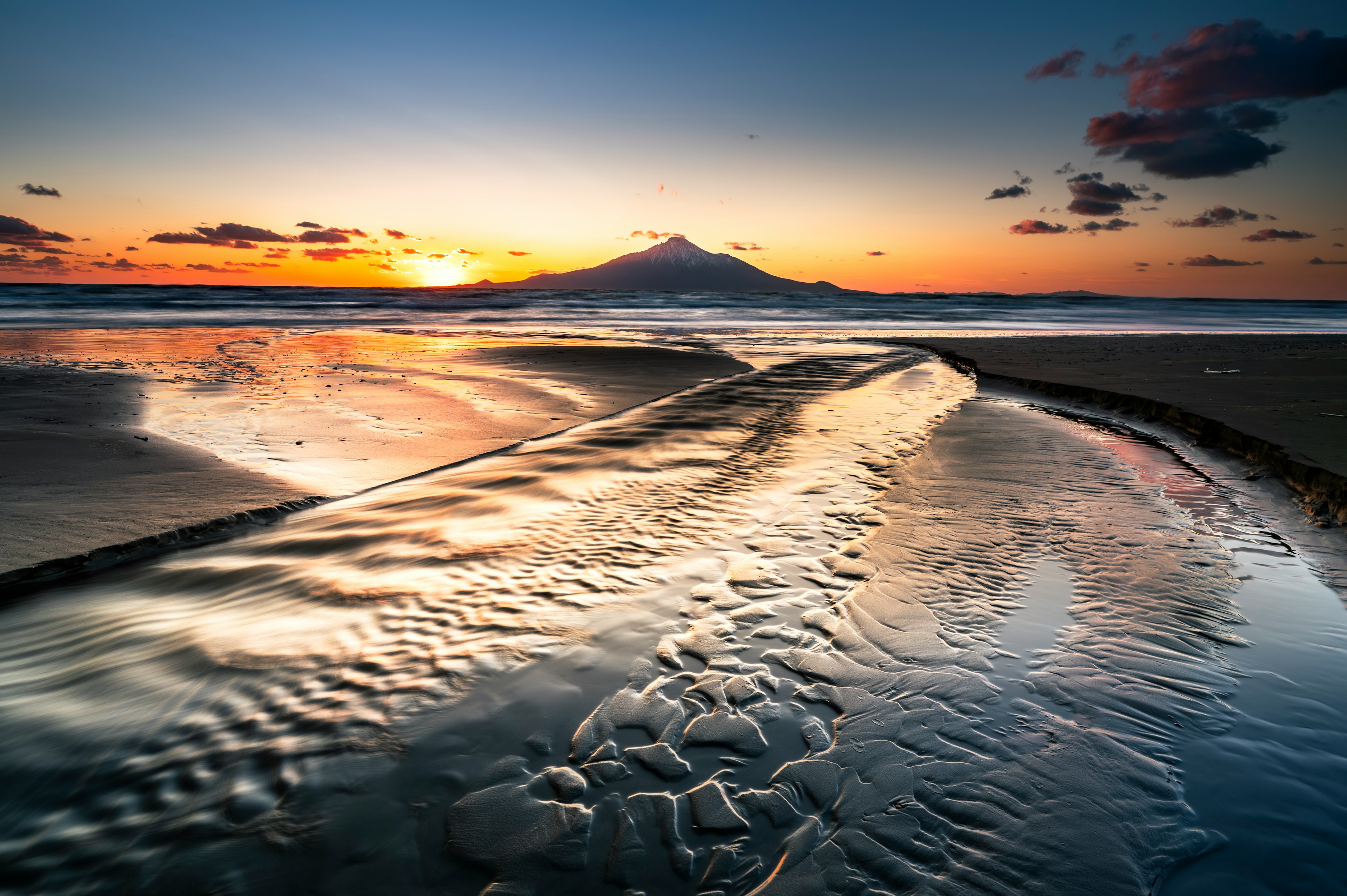 Stunning sunset over the ocean with flowing water patterns