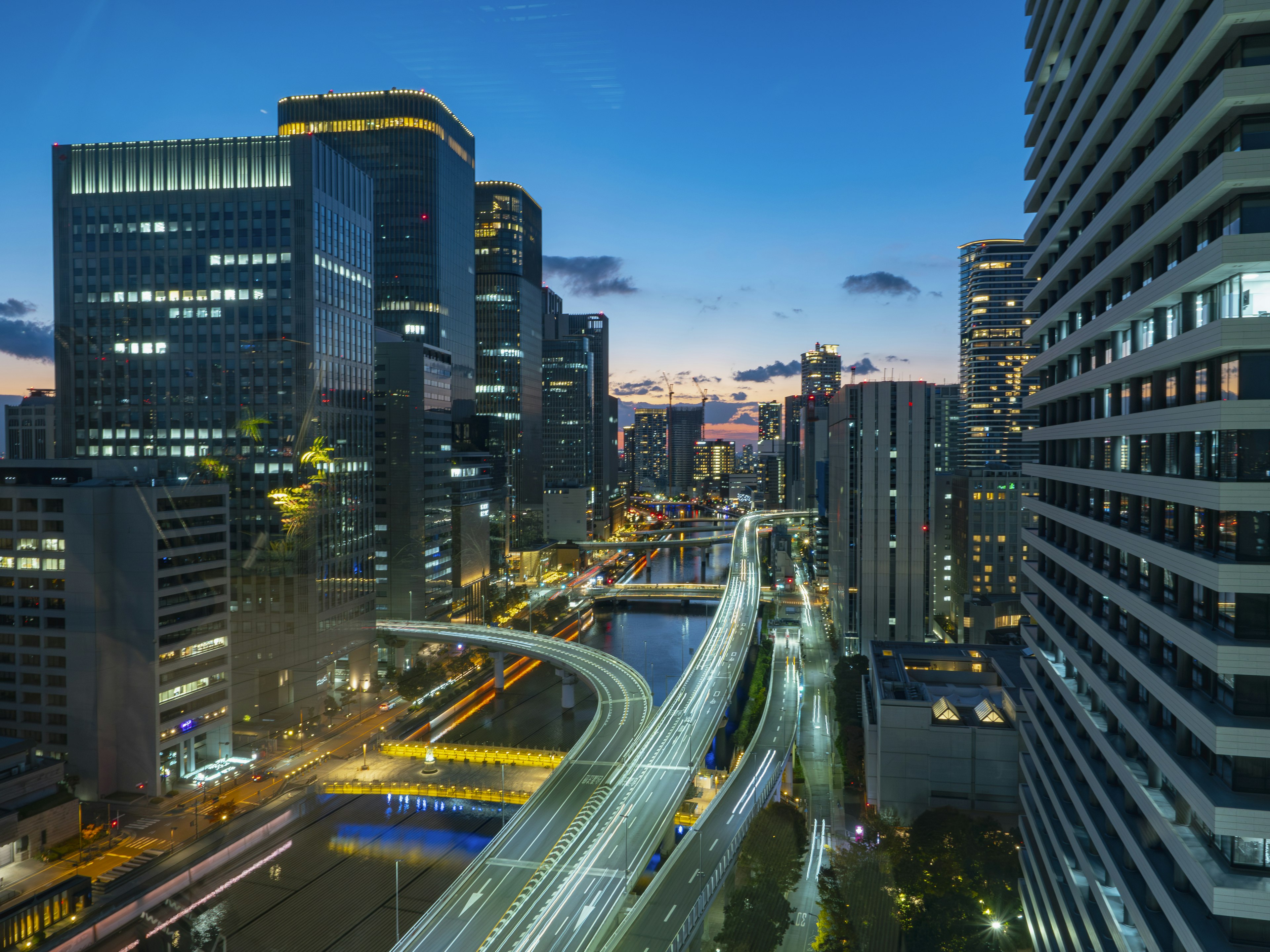 Night cityscape with skyscrapers and a highway