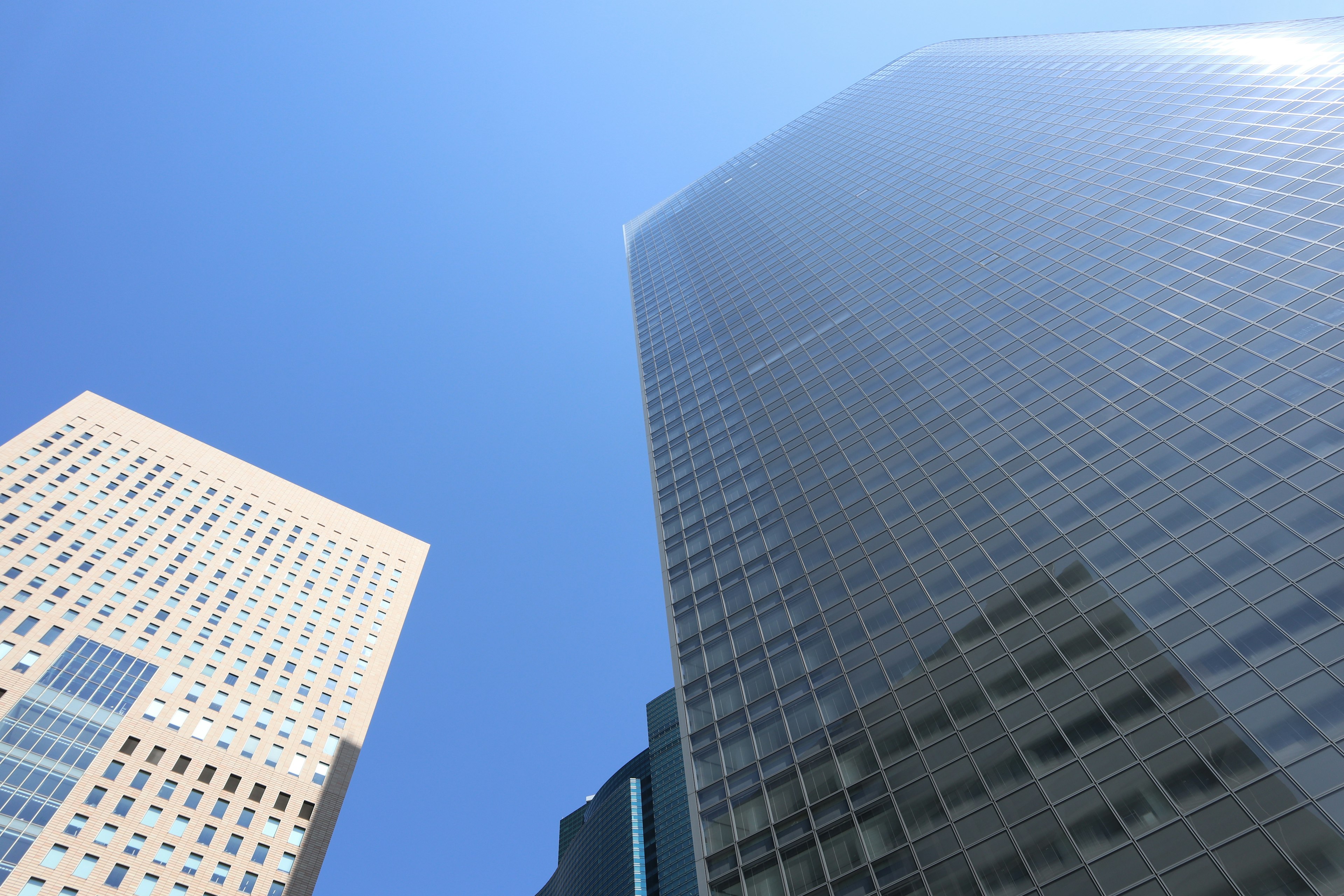 Cityscape featuring tall skyscrapers under a clear blue sky