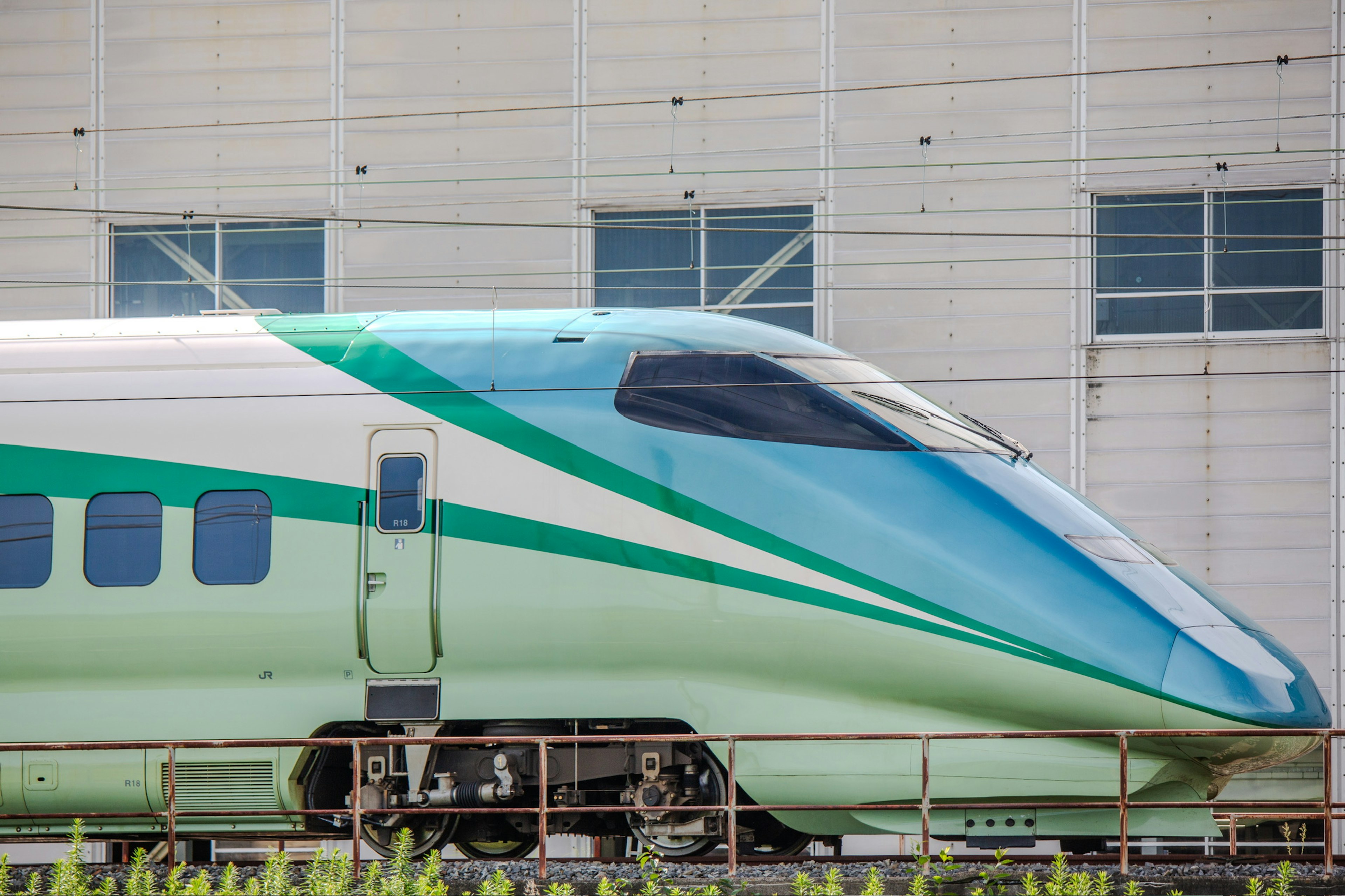 Shinkansen with streamlined design and teal exterior