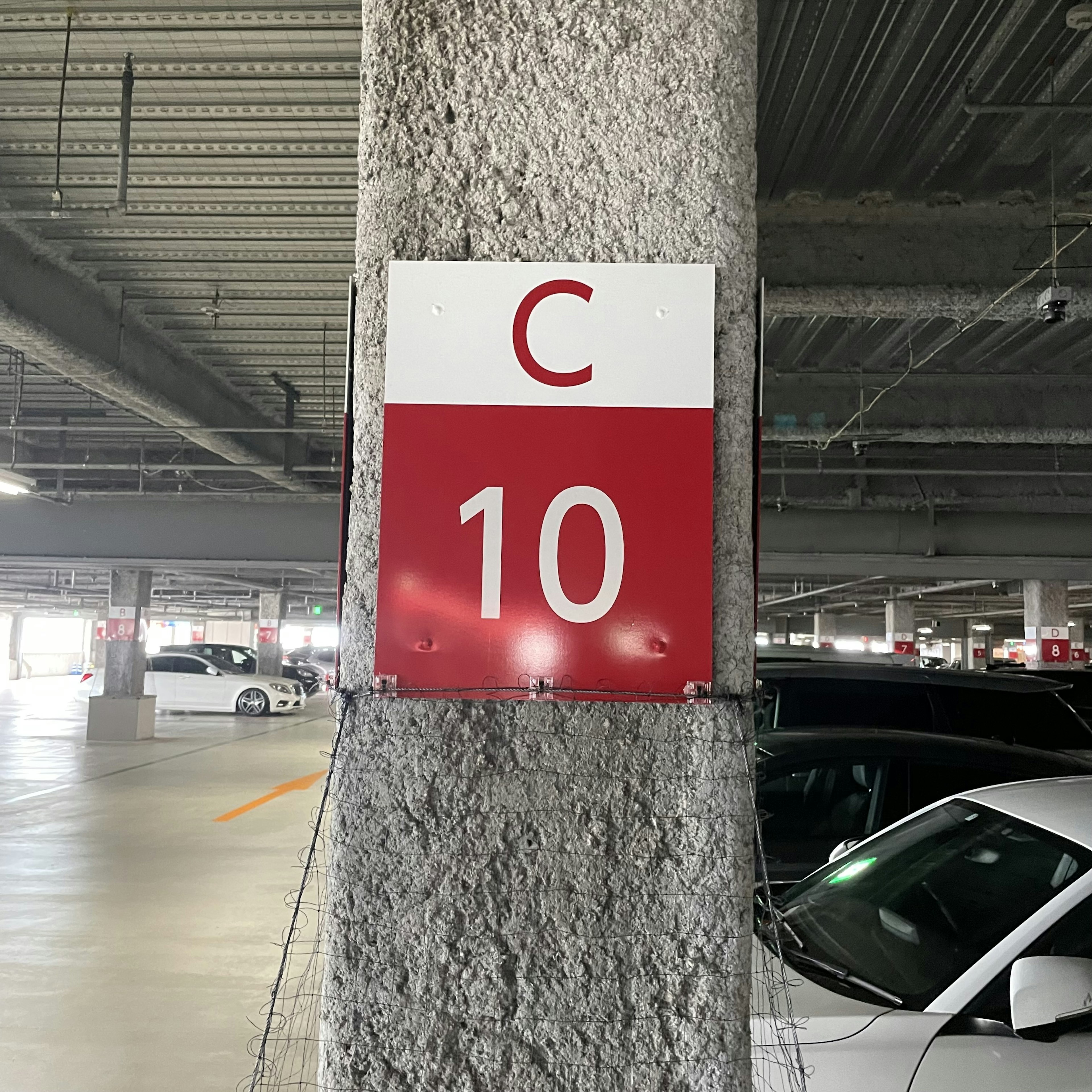 Sign C10 mounted on a parking garage pillar