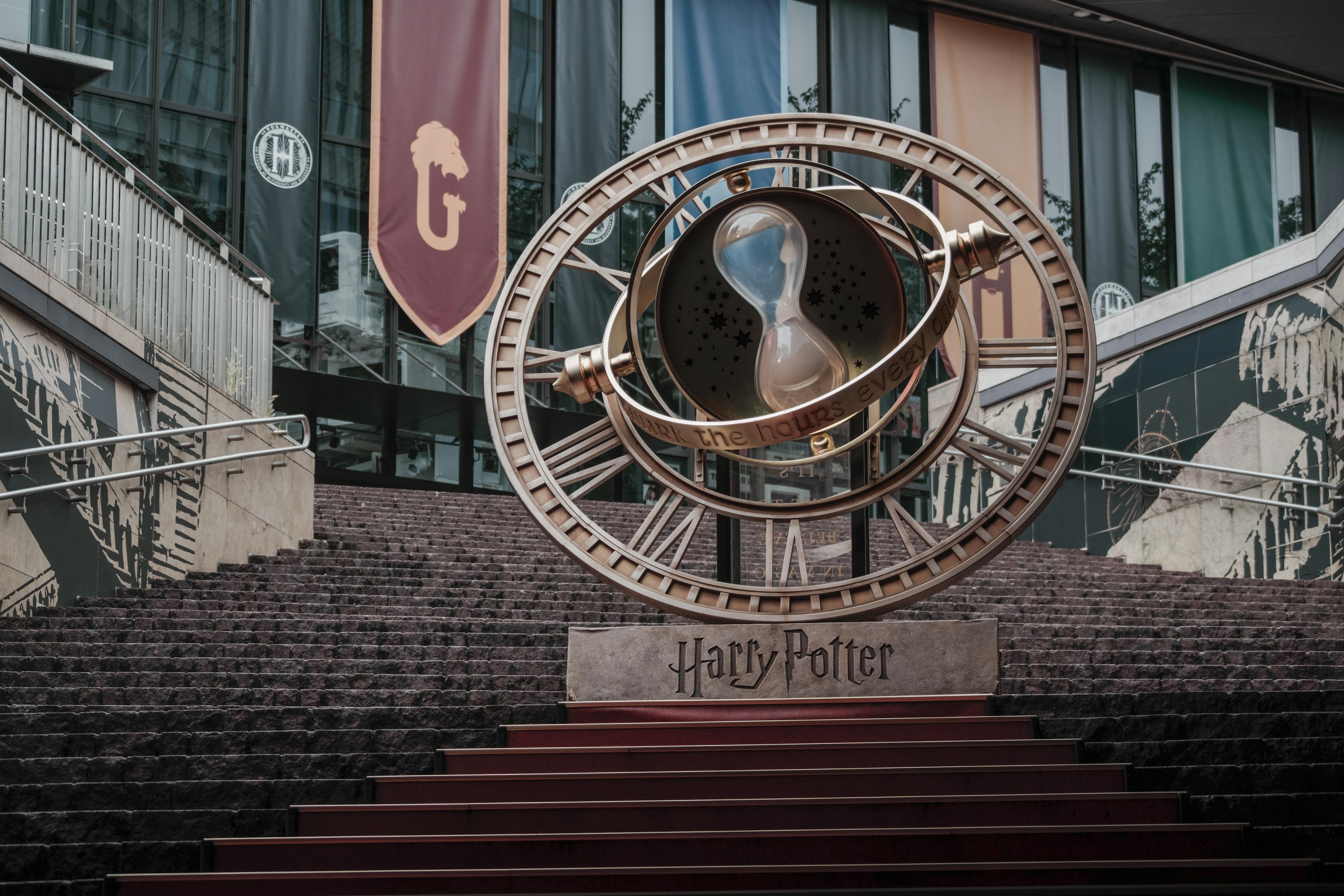 A large astronomical device themed around Harry Potter stands at the foot of a staircase