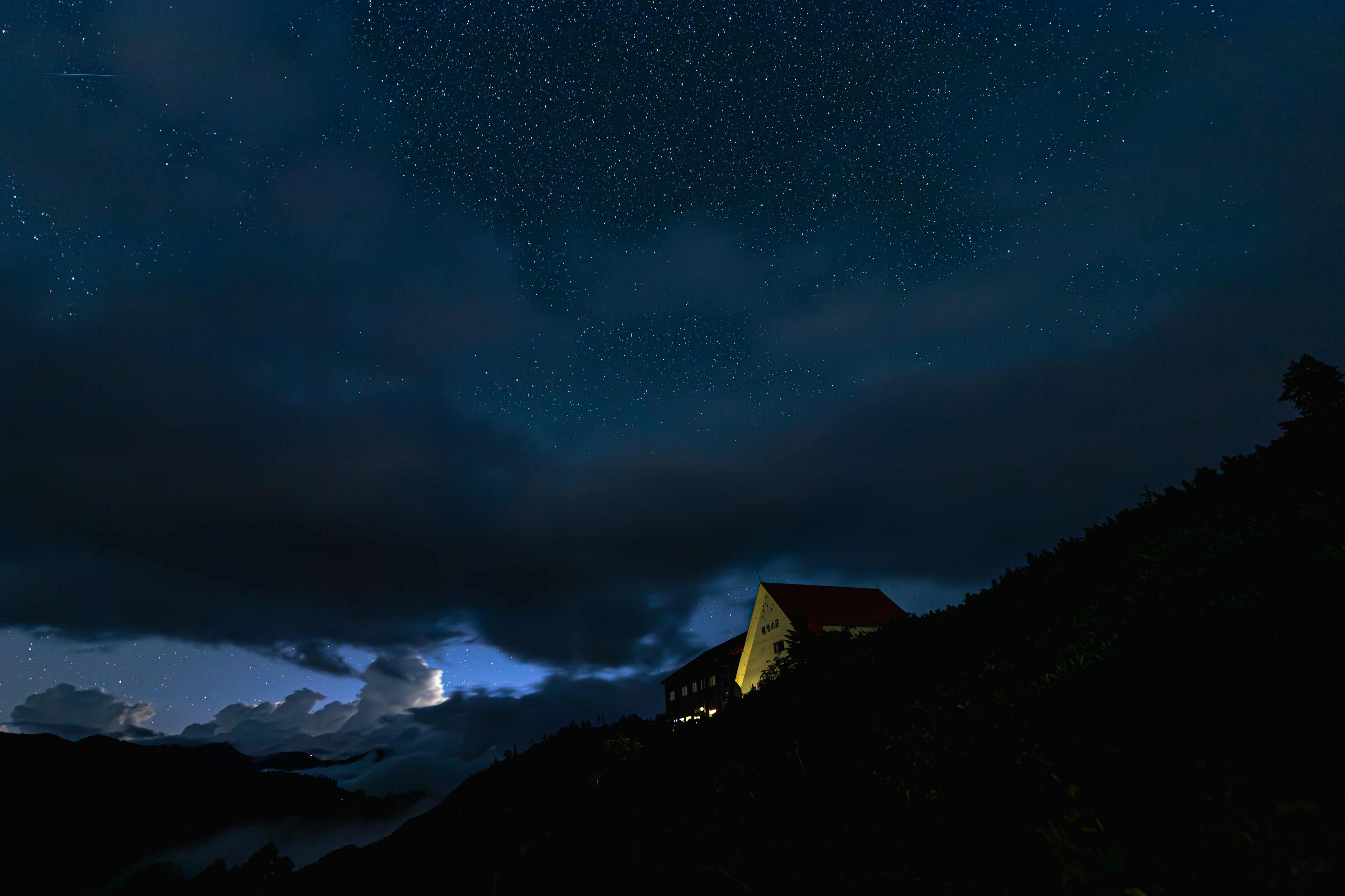 夜空に輝く星々と山のシルエットが見える風景