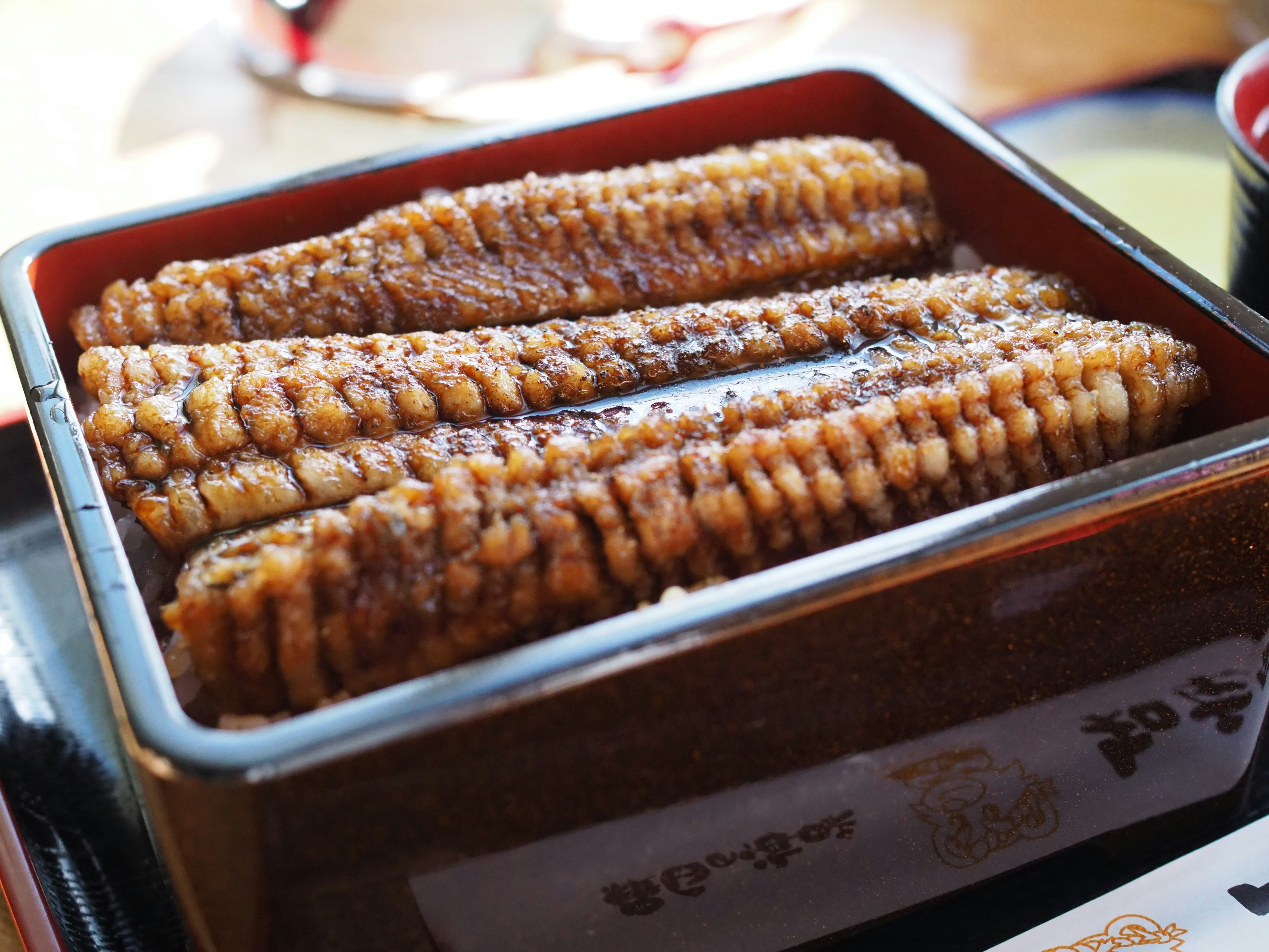 Grilled eel served in a red box