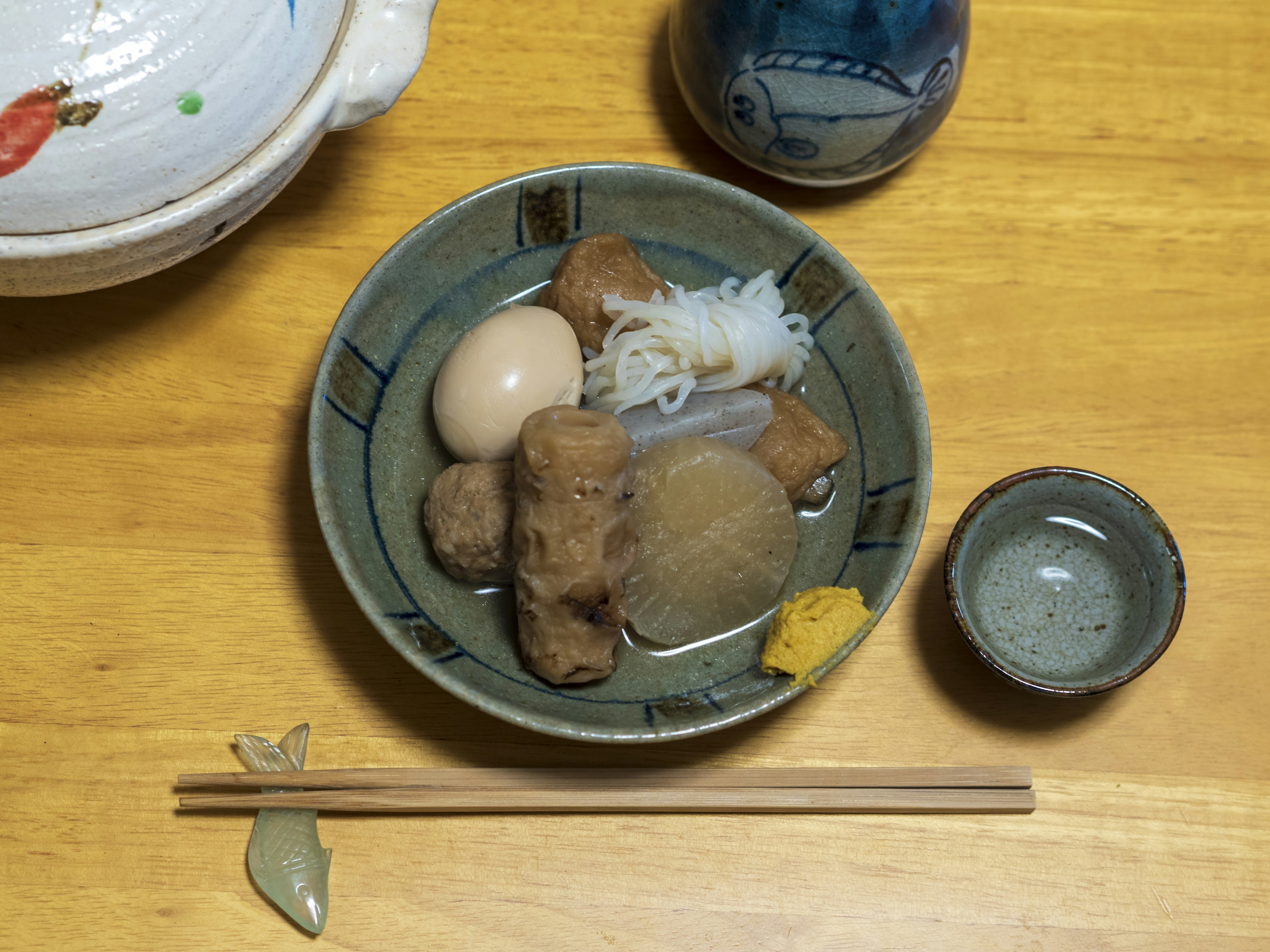 A plate of oden featuring ingredients like boiled eggs daikon konnyaku and fish cakes