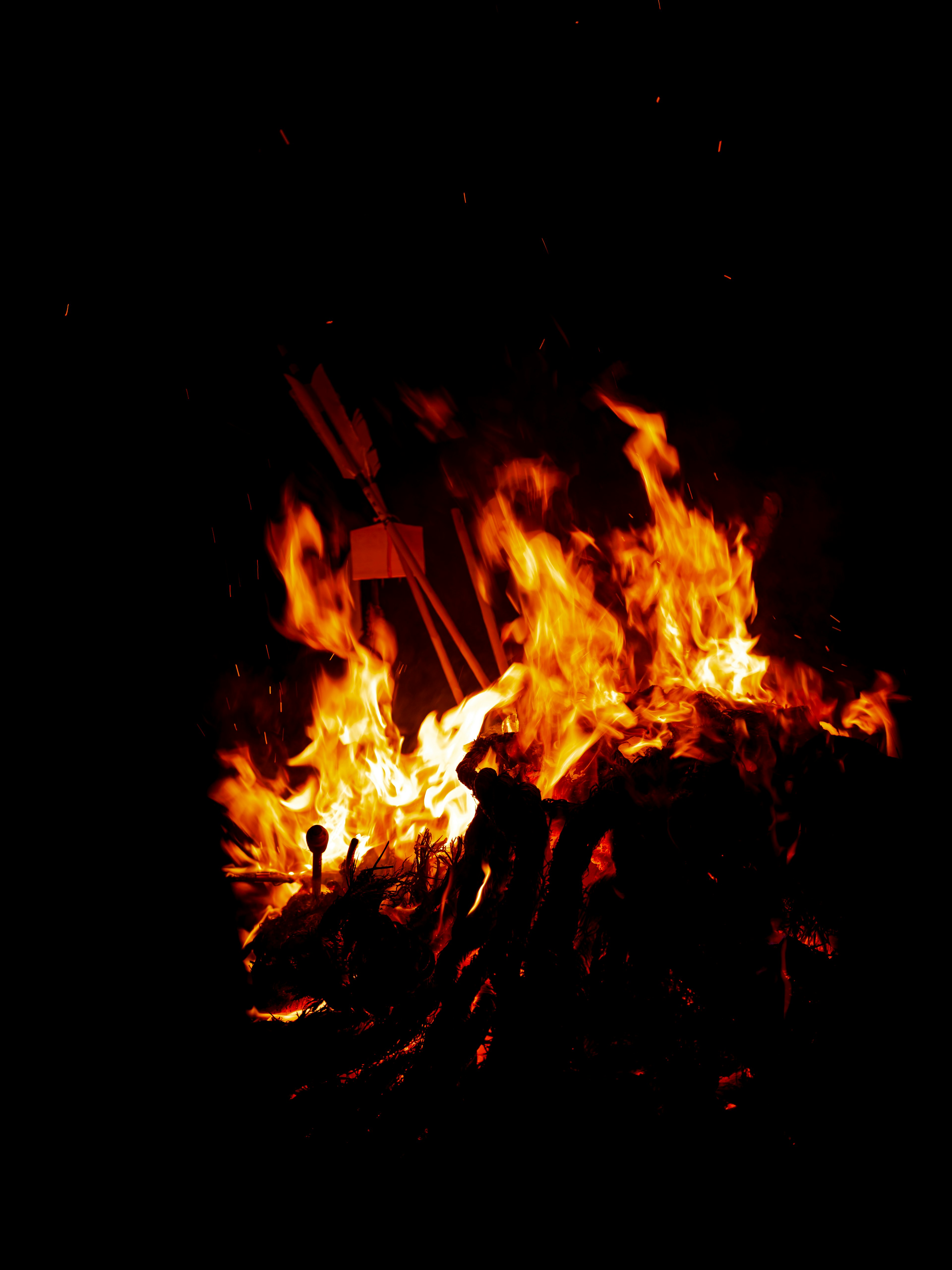 Flames dancing in a nighttime bonfire