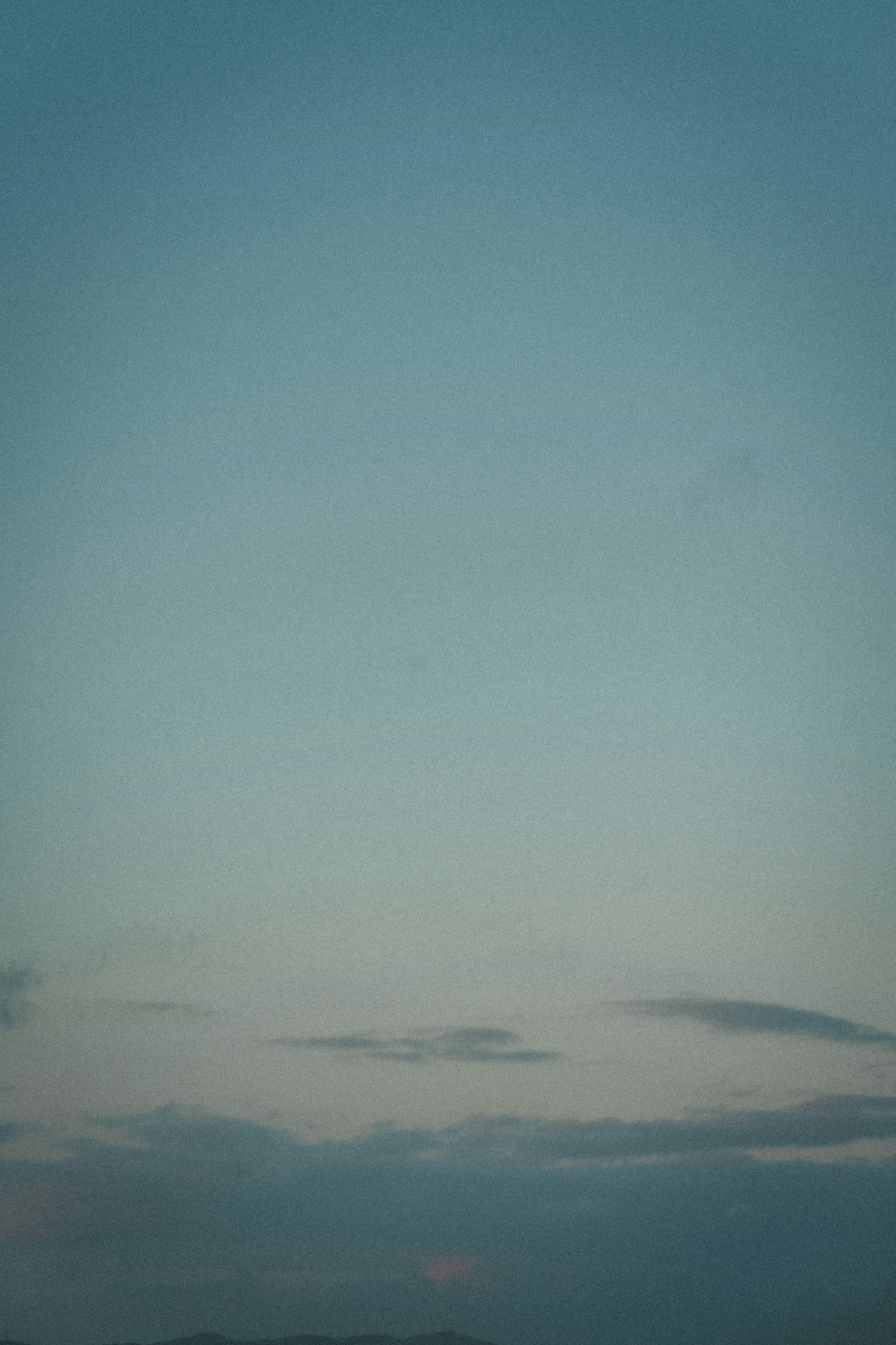 Calm blue sky with wispy clouds