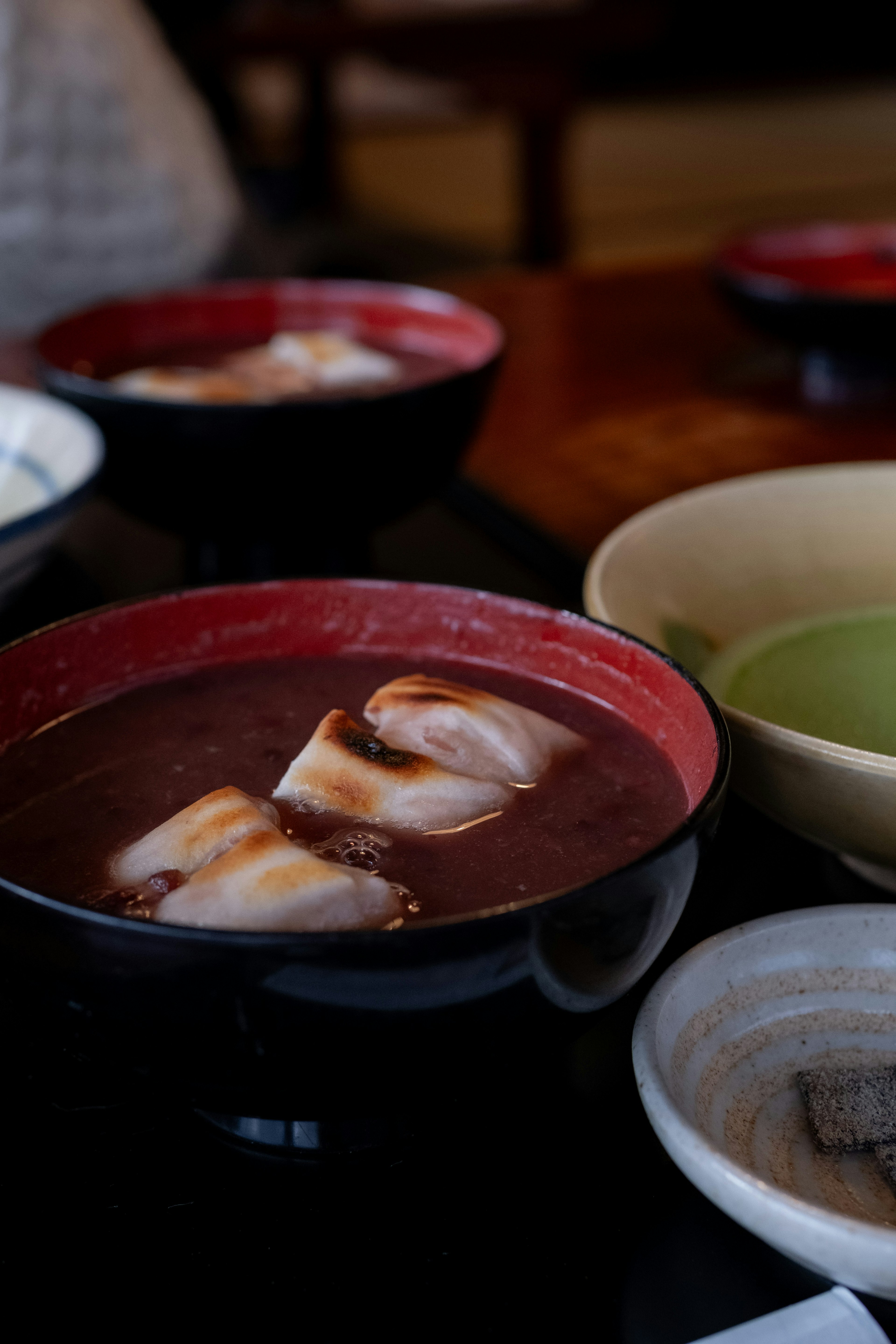 Sweet red bean soup with floating mochi in bowls