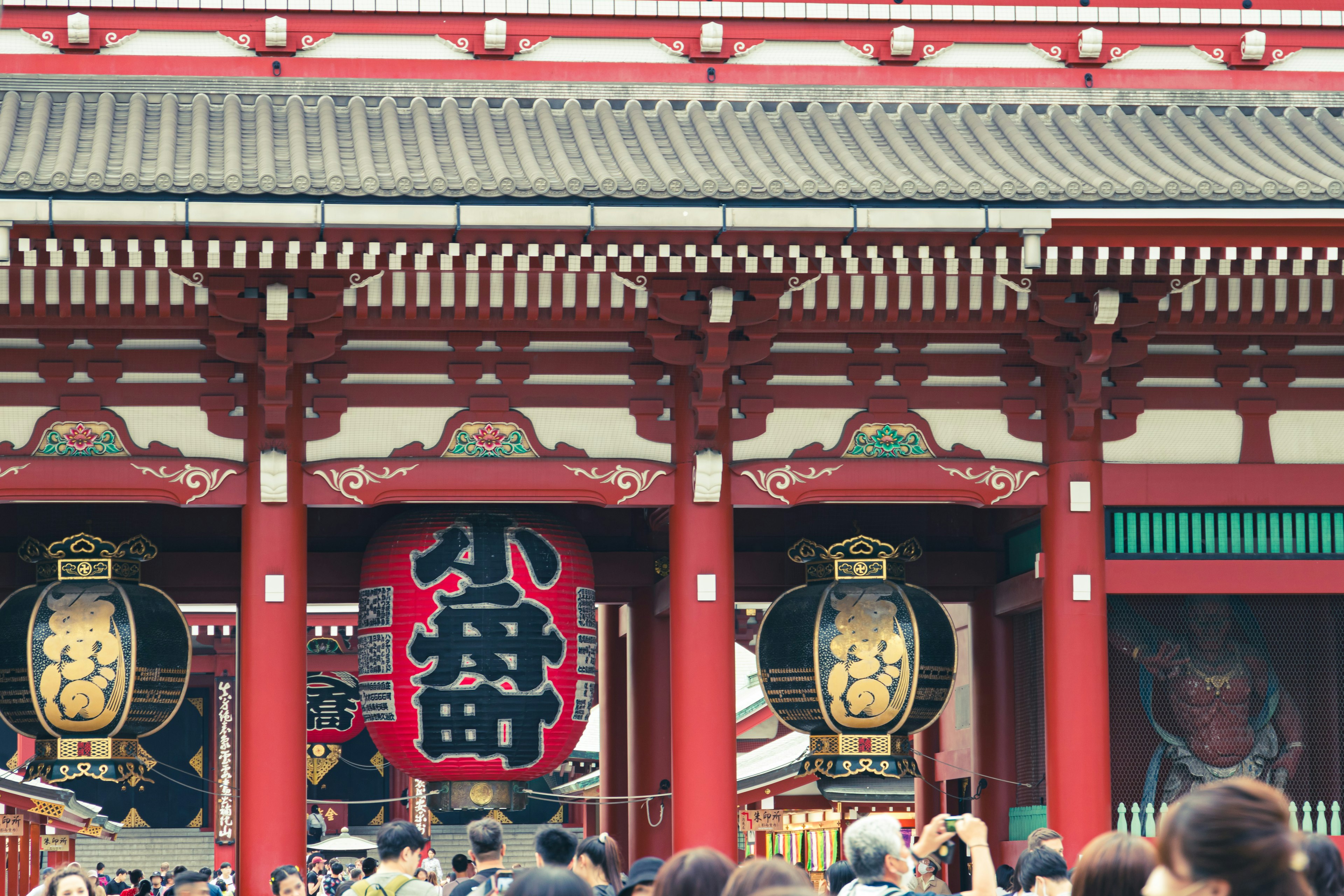 Escena concurrida con las puertas rojas y las grandes linternas del templo Senso-ji