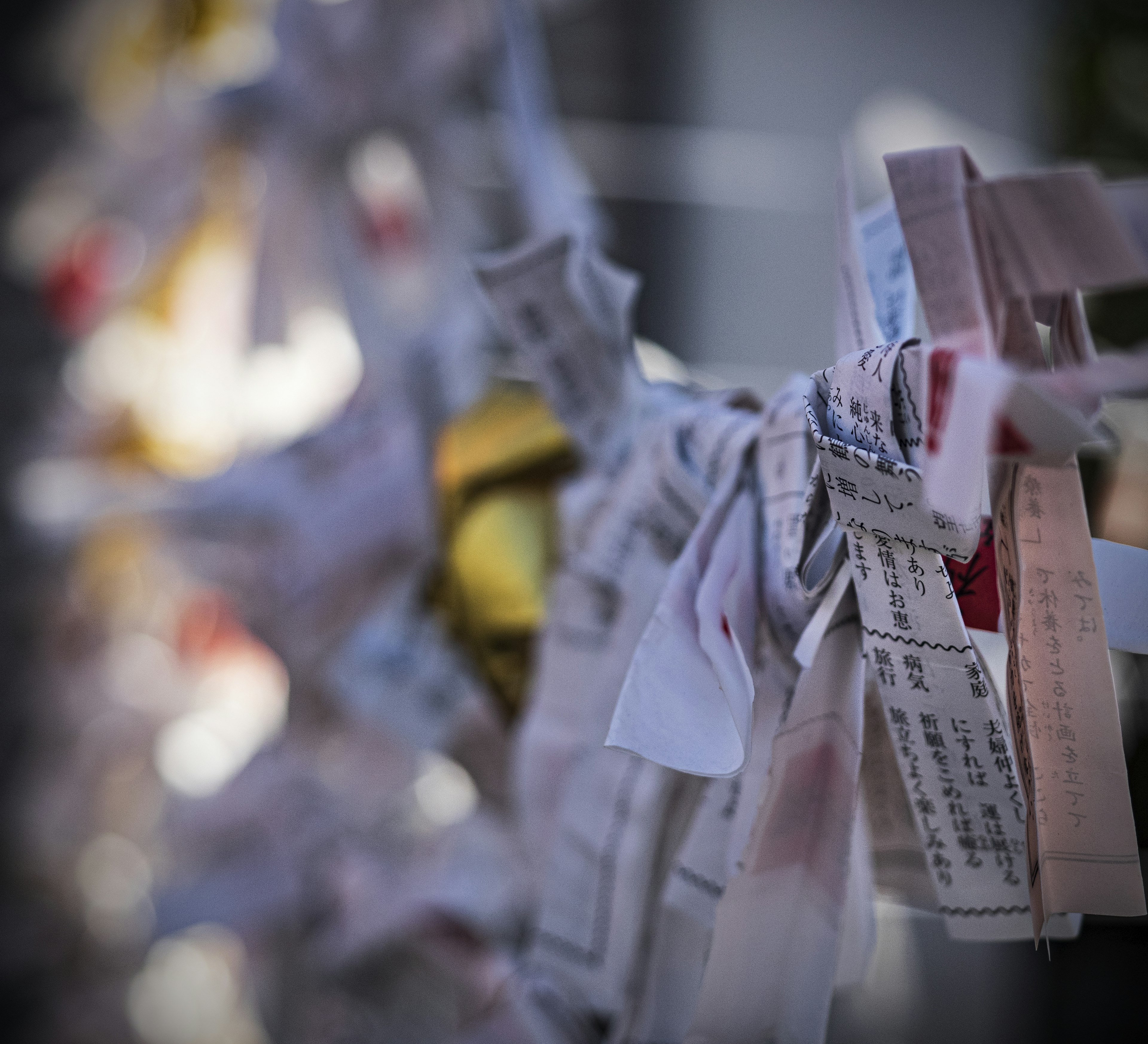 Colorful paper tied together creating a scene representing prayers or wishes