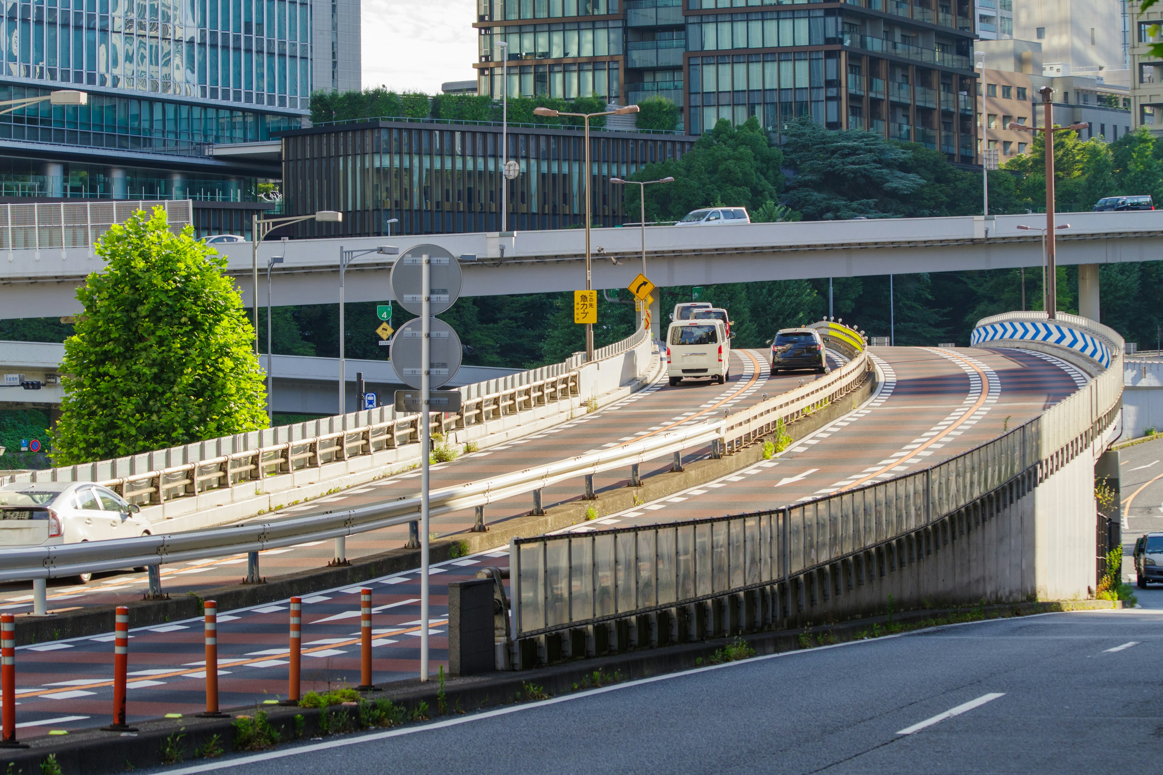 Cảnh đô thị với đường cao tốc cong và các tòa nhà hiện đại ở Tokyo