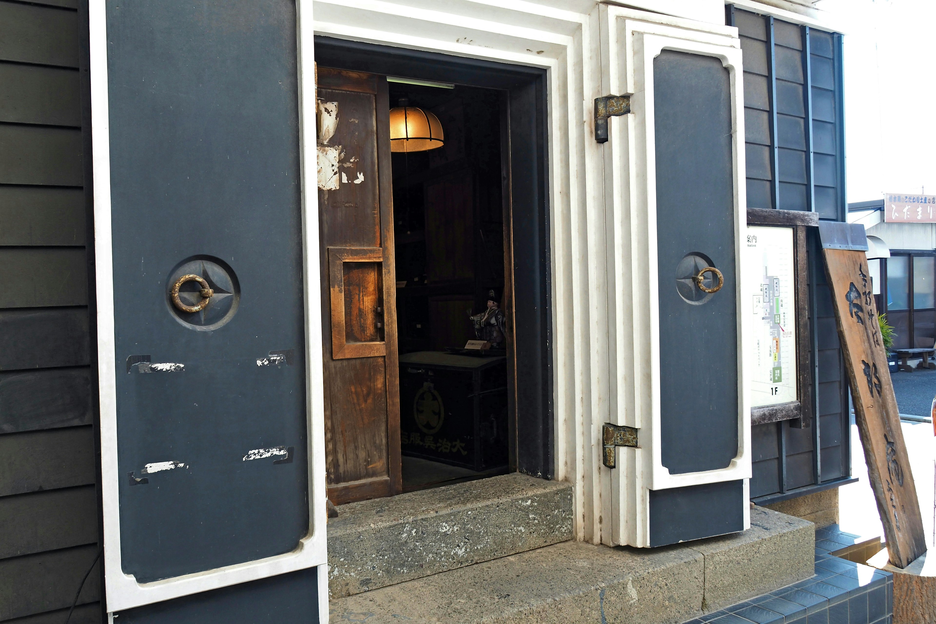 Entrance of an old building featuring distinctive doors and stone steps