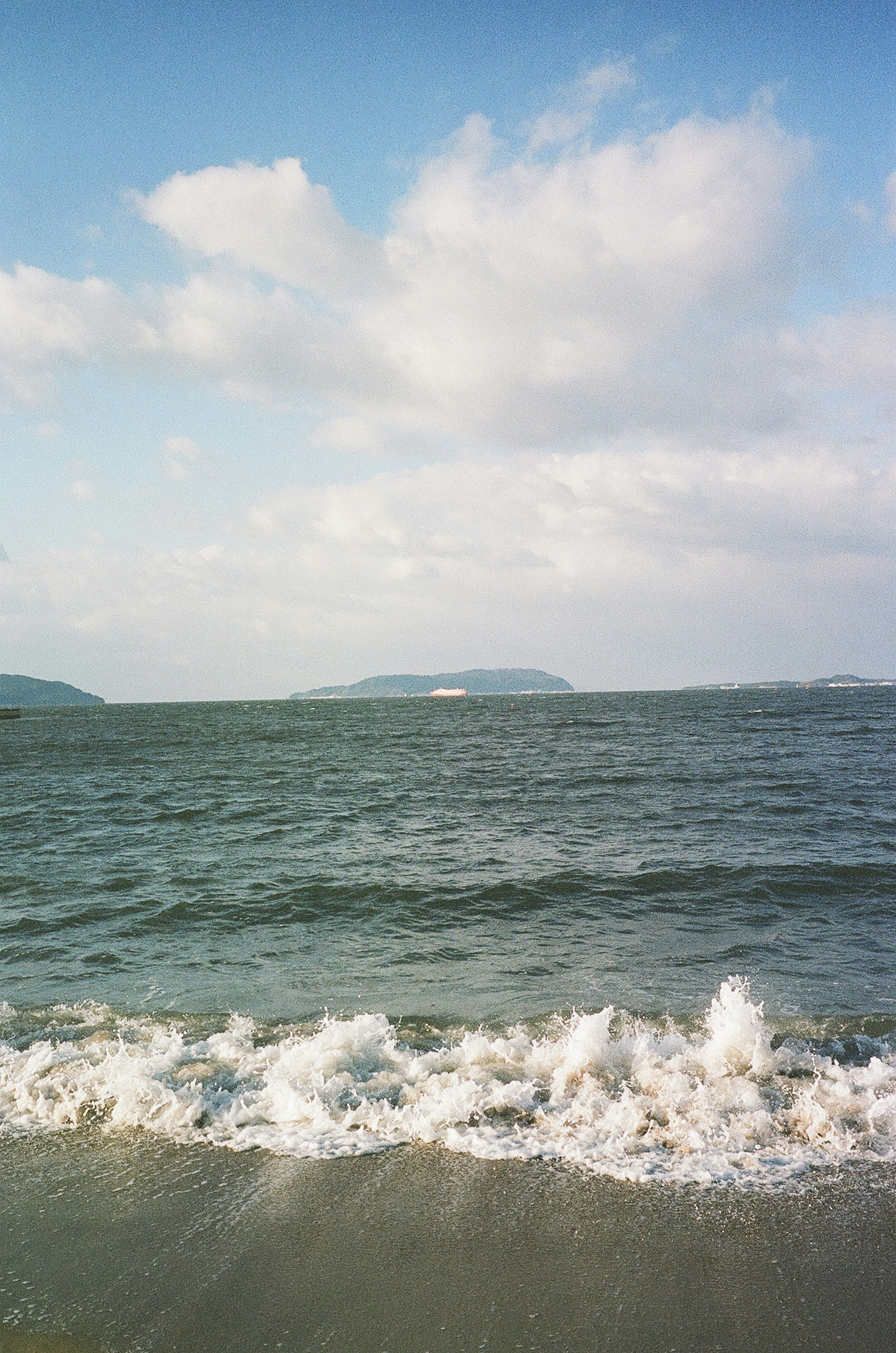 青い海と白い波が打ち寄せる美しい風景