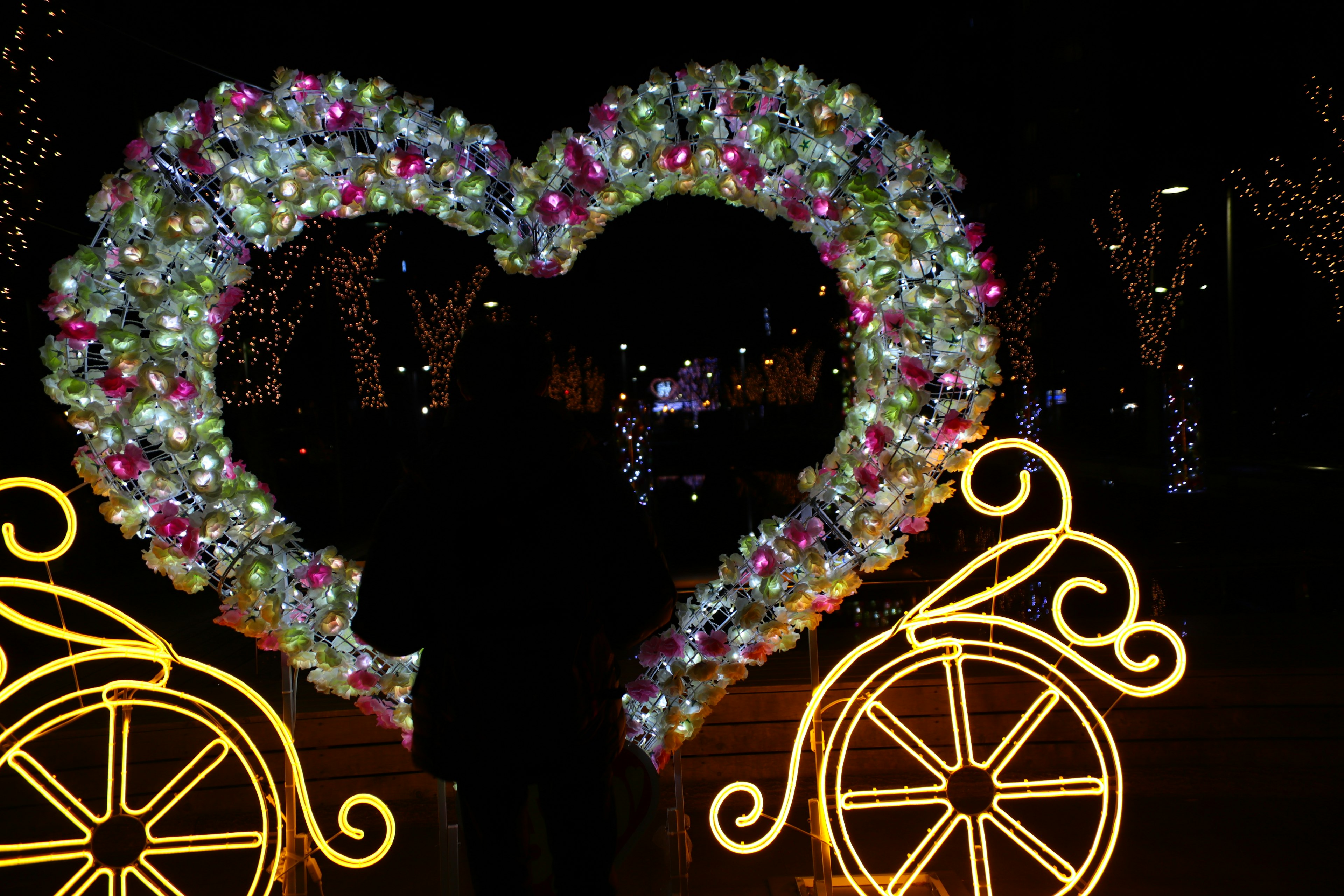 Night scene featuring heart-shaped decoration and bicycle lights