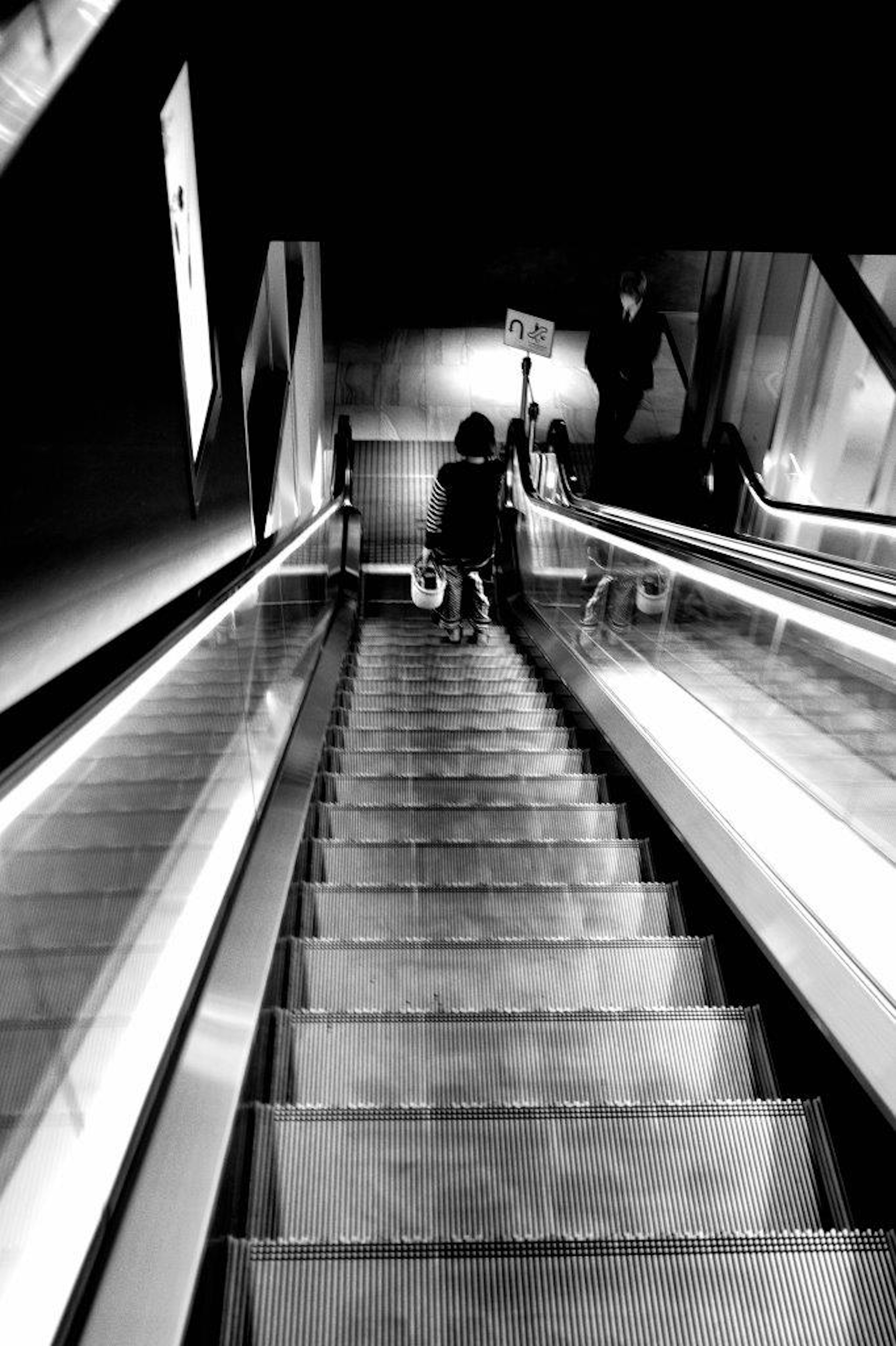 Monochrome image of a person descending stairs