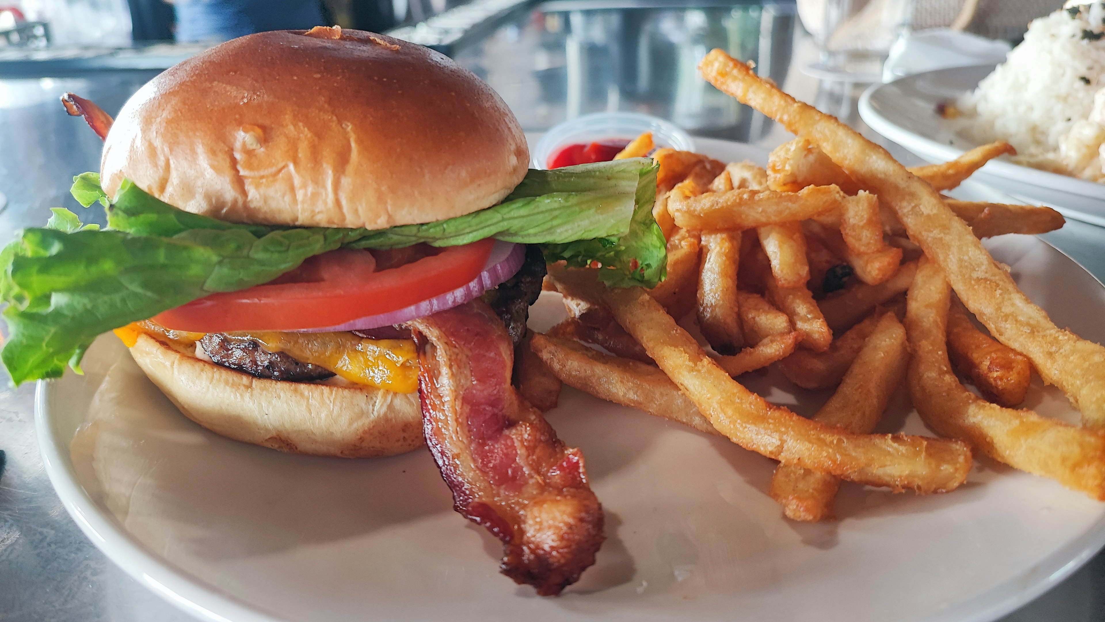 Bacon lettuce tomato burger with French fries