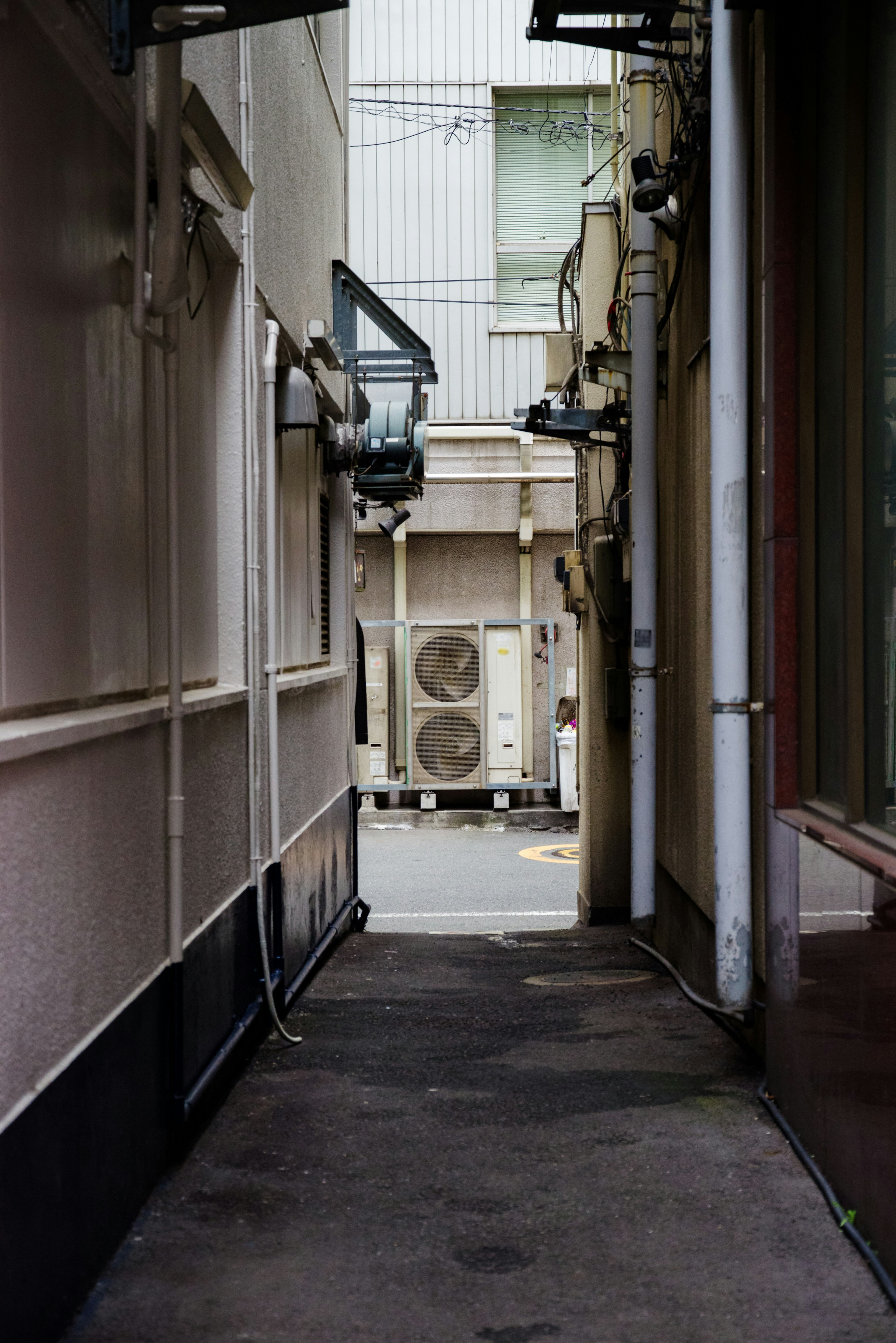 Narrow alleyway with visible air conditioning units