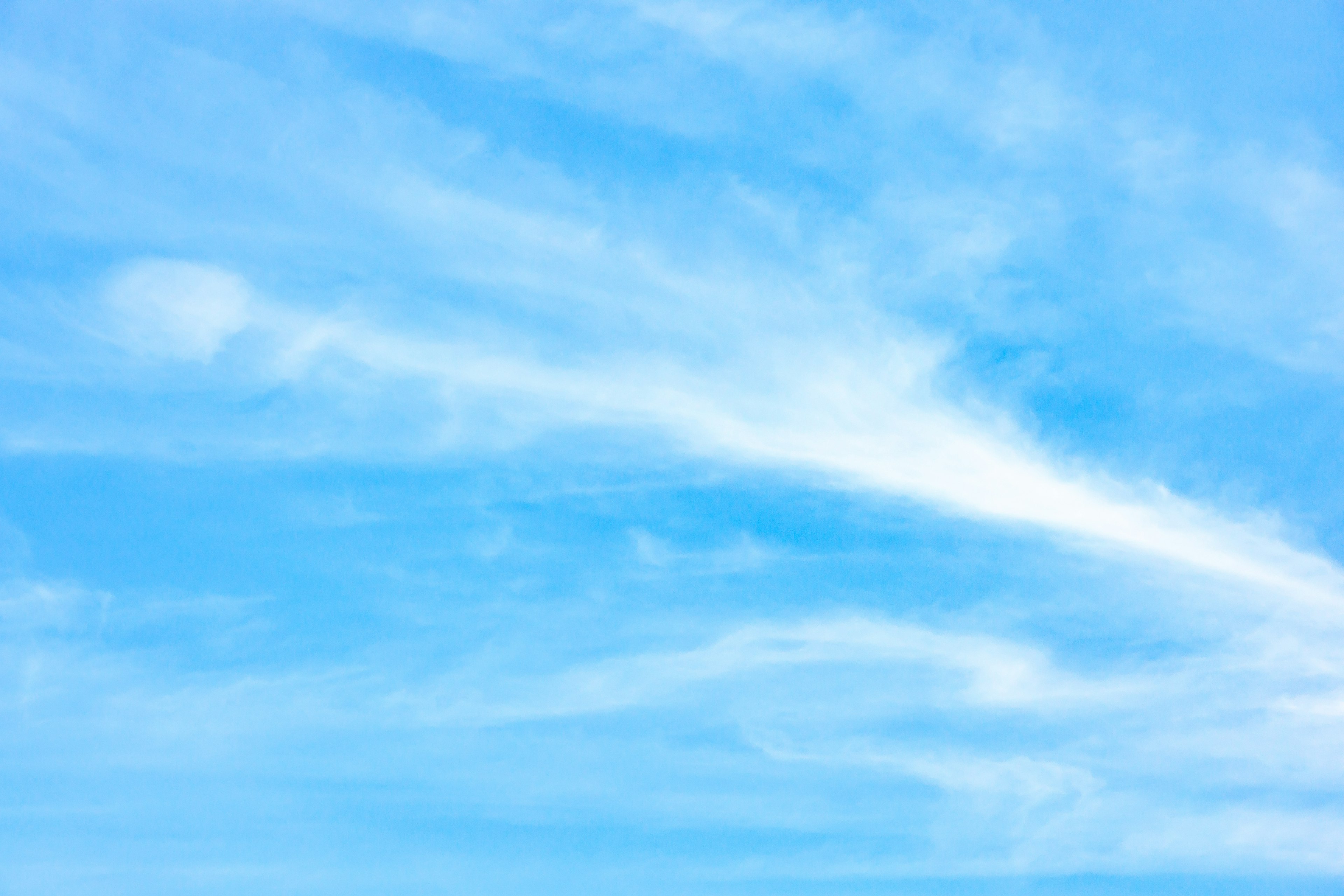 A serene view of white clouds spread across a blue sky