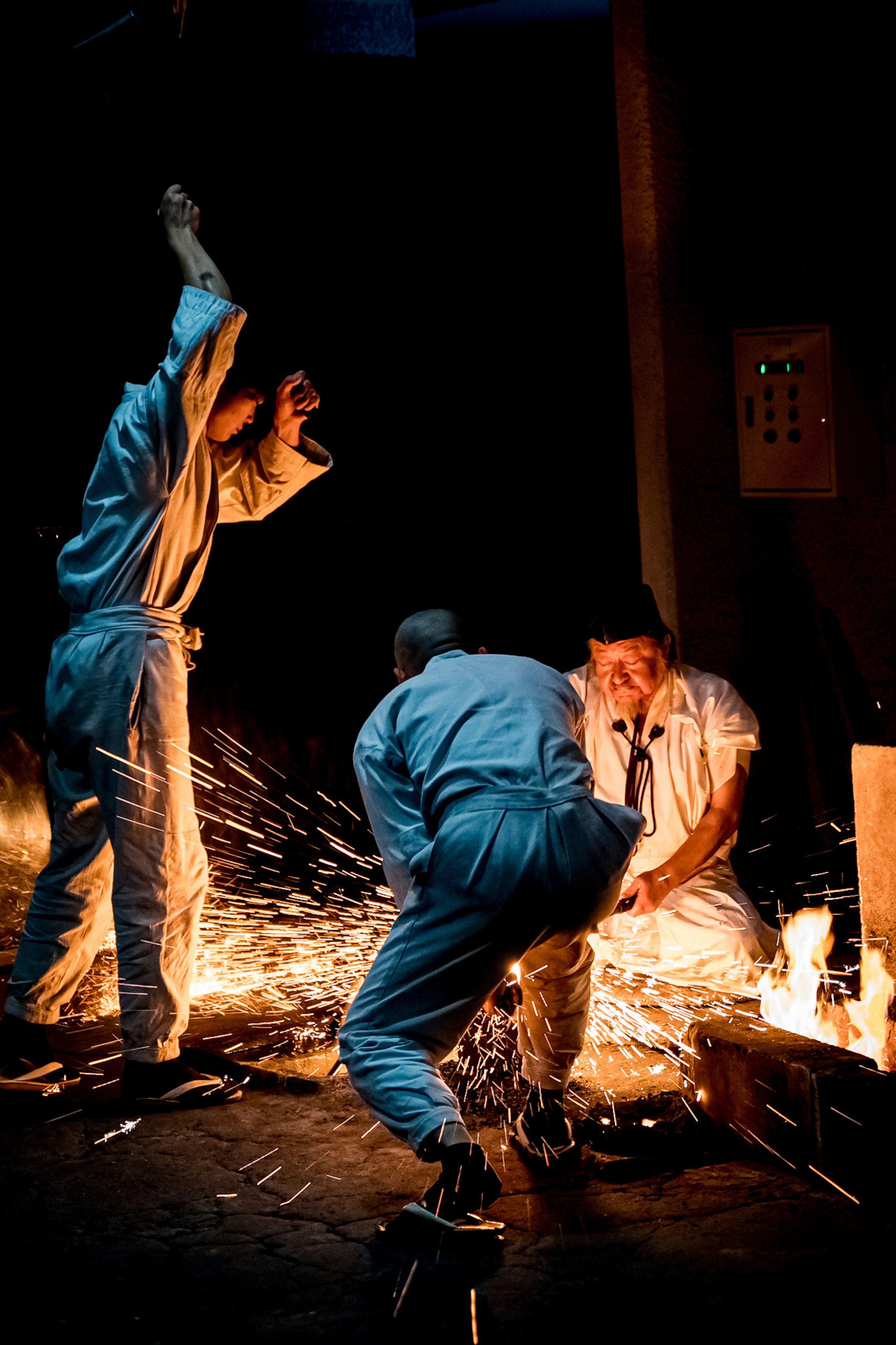 Workers engaged in welding activity generating sparks