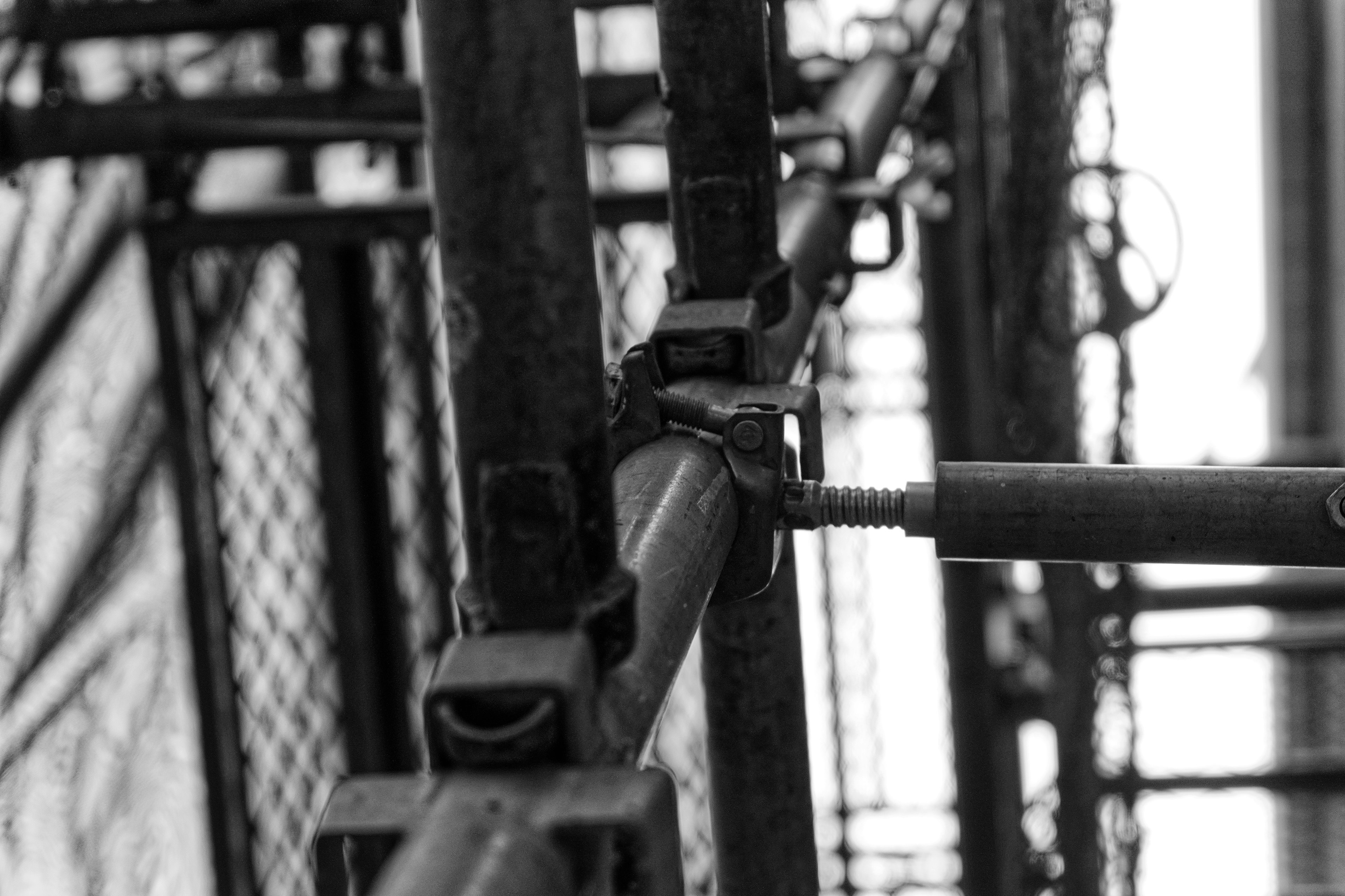 Close-up of a steel scaffolding connection in black and white