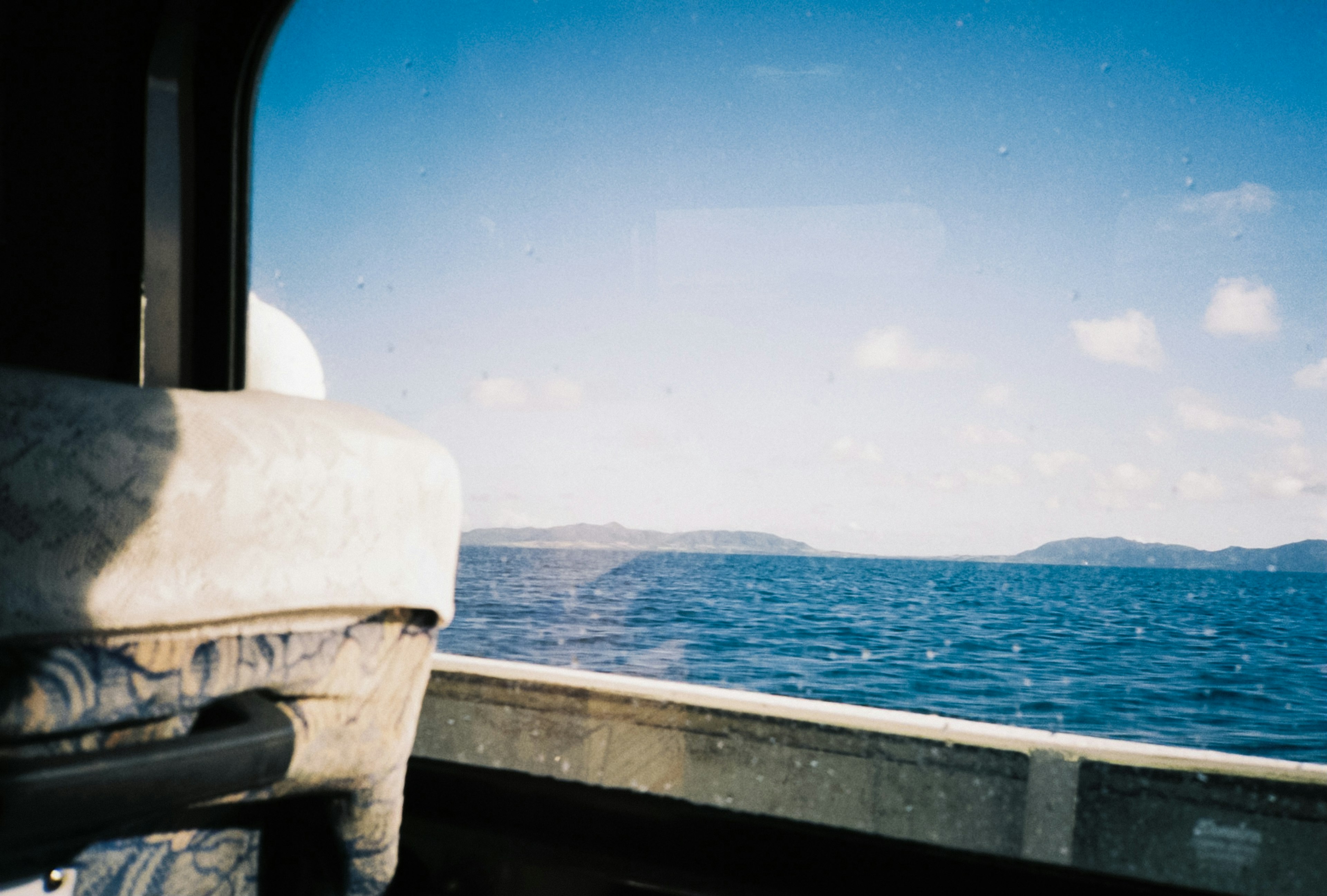 View of blue sea and sky from a boat window