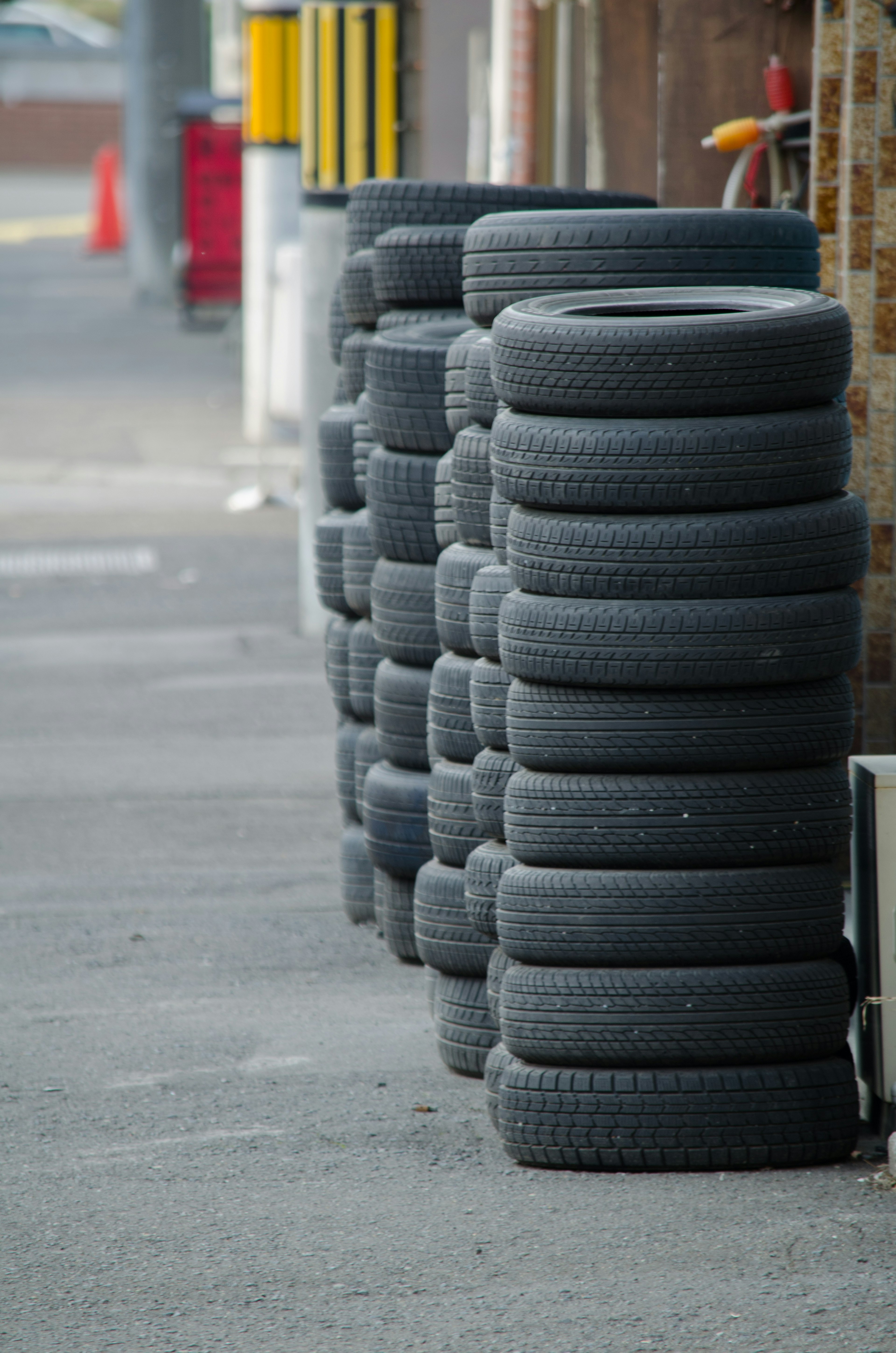 Stack of black tires arranged along the street