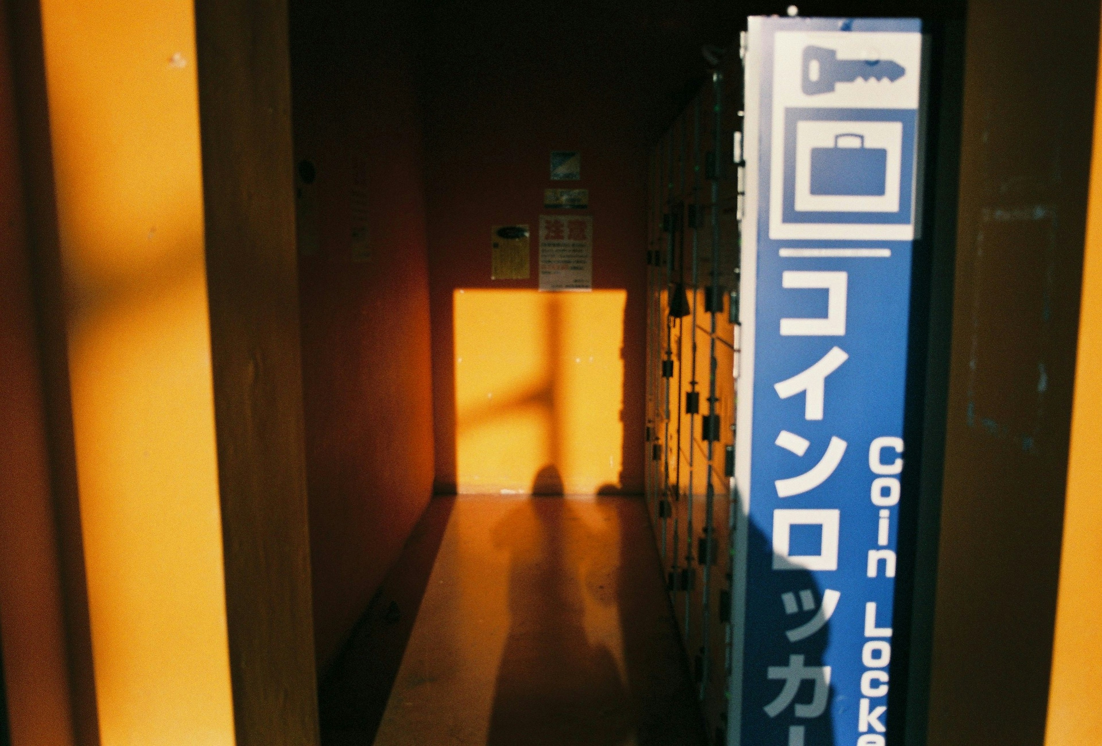 Photo of a corridor with coin locker sign and lockers