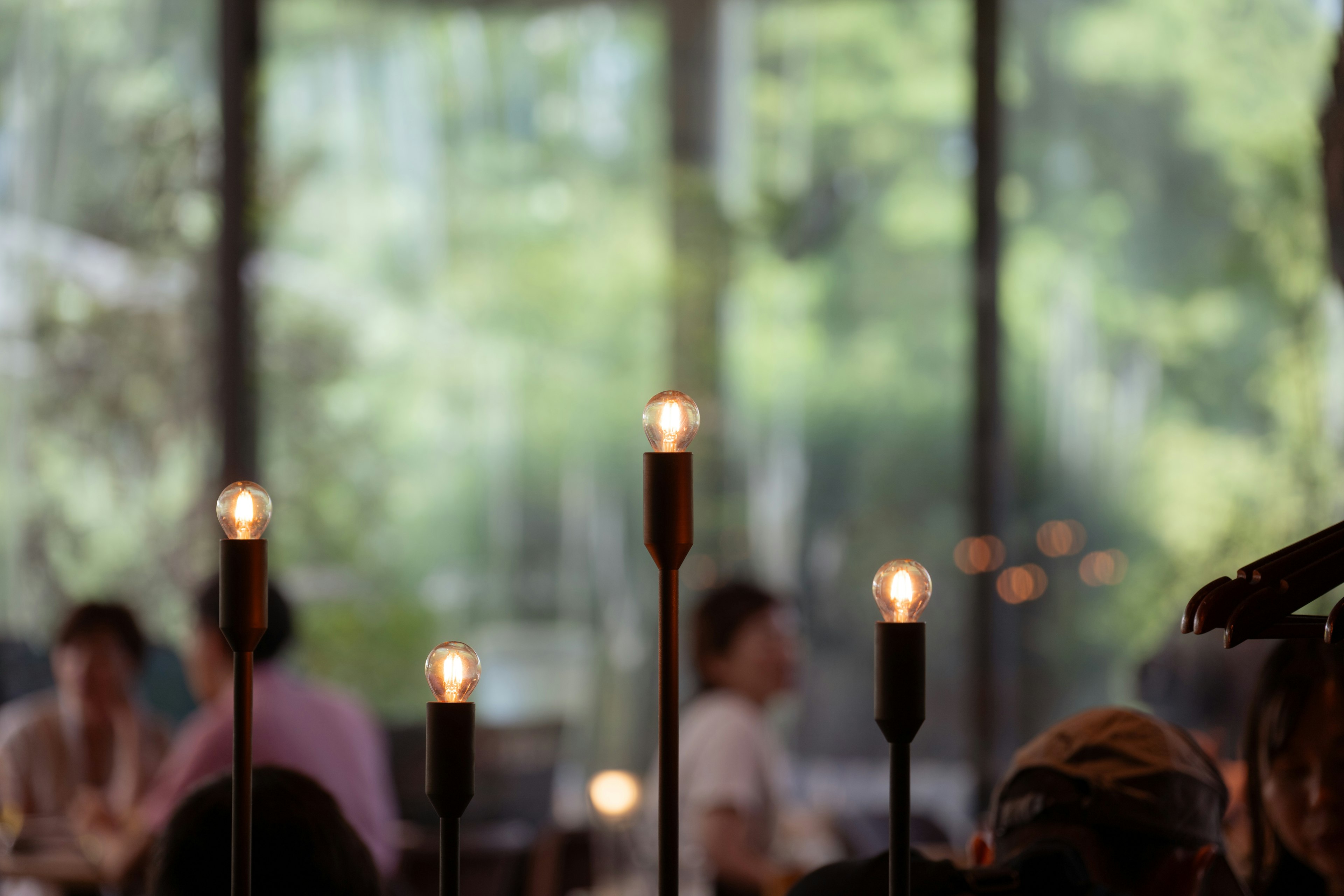 Candles on a restaurant table with a blurred green background