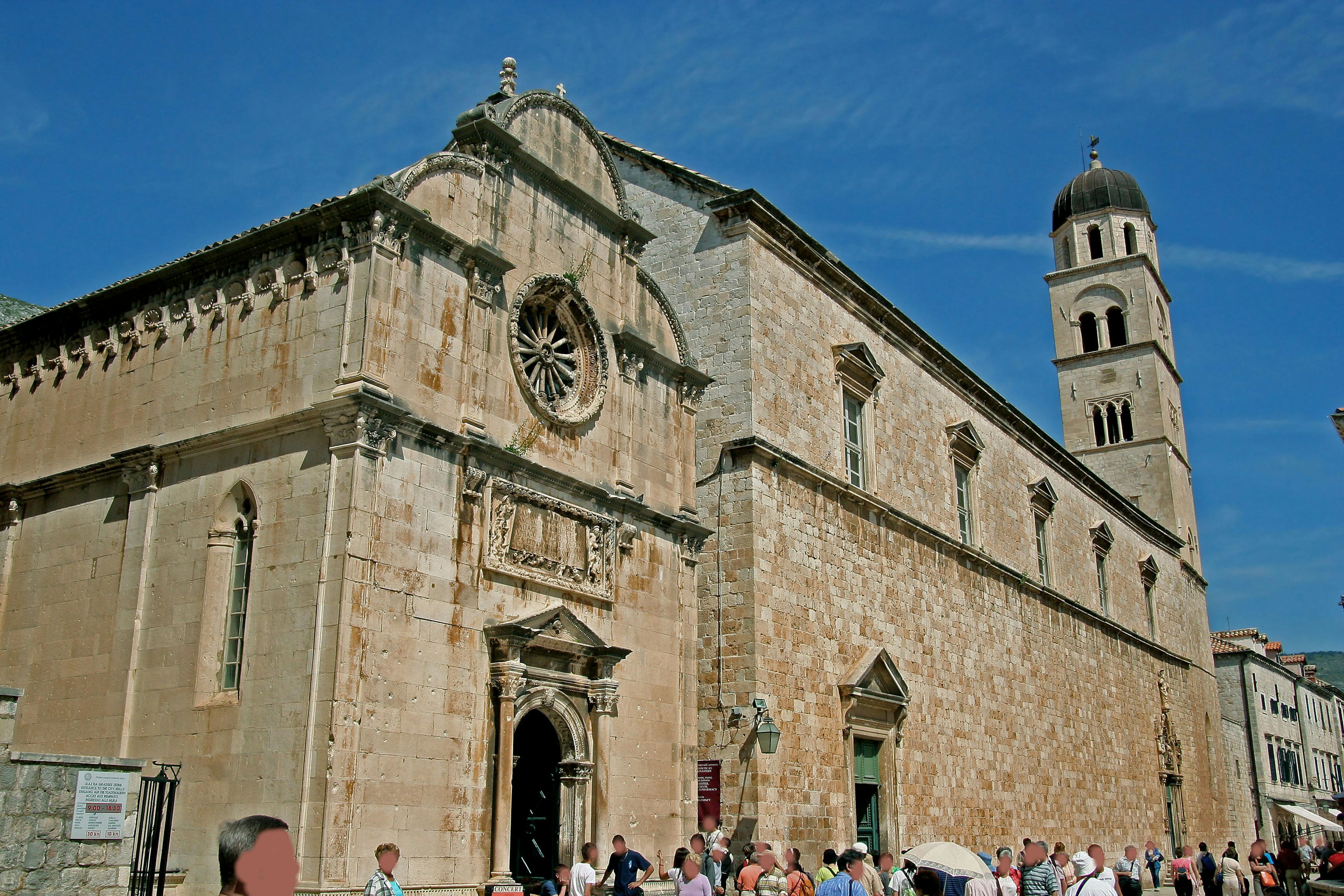 Beautiful stone church with people under a blue sky