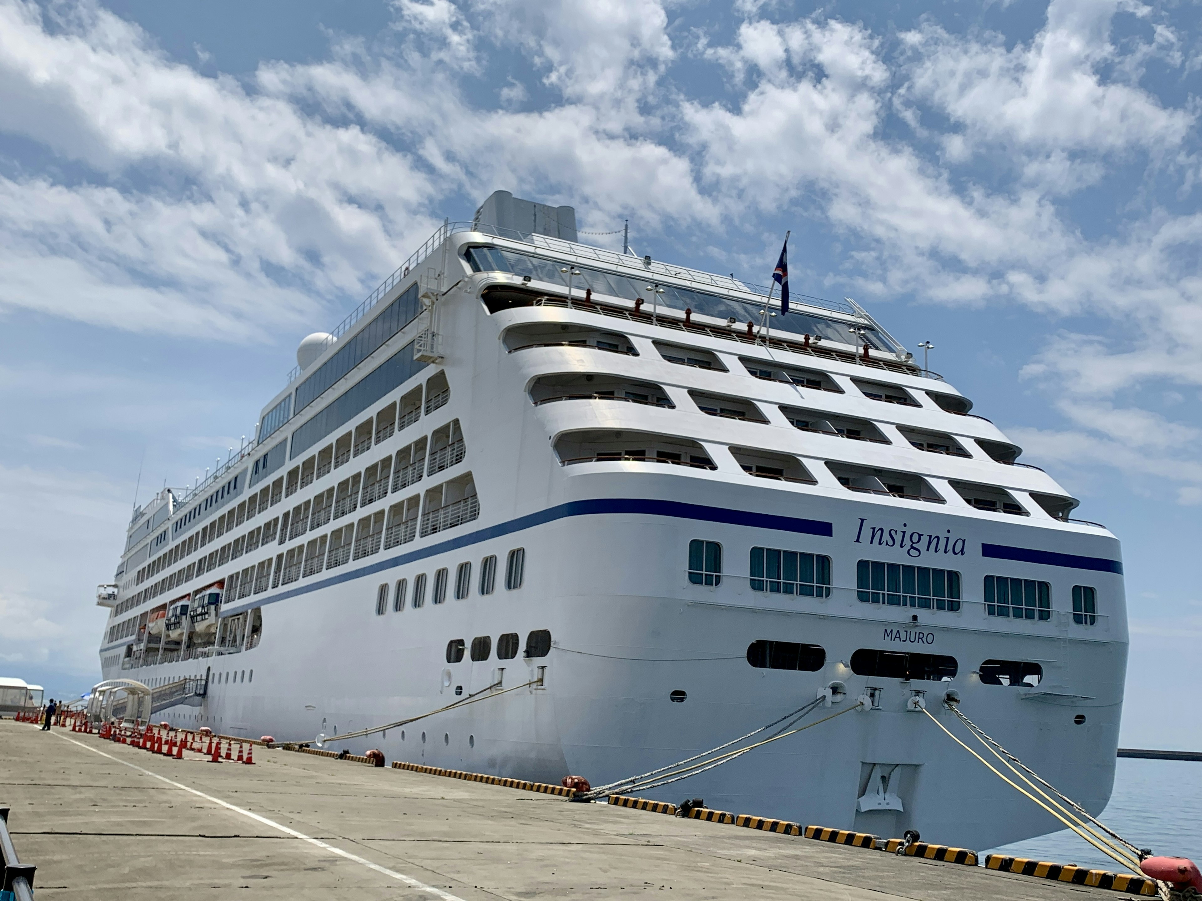 Large cruise ship docked under a blue sky