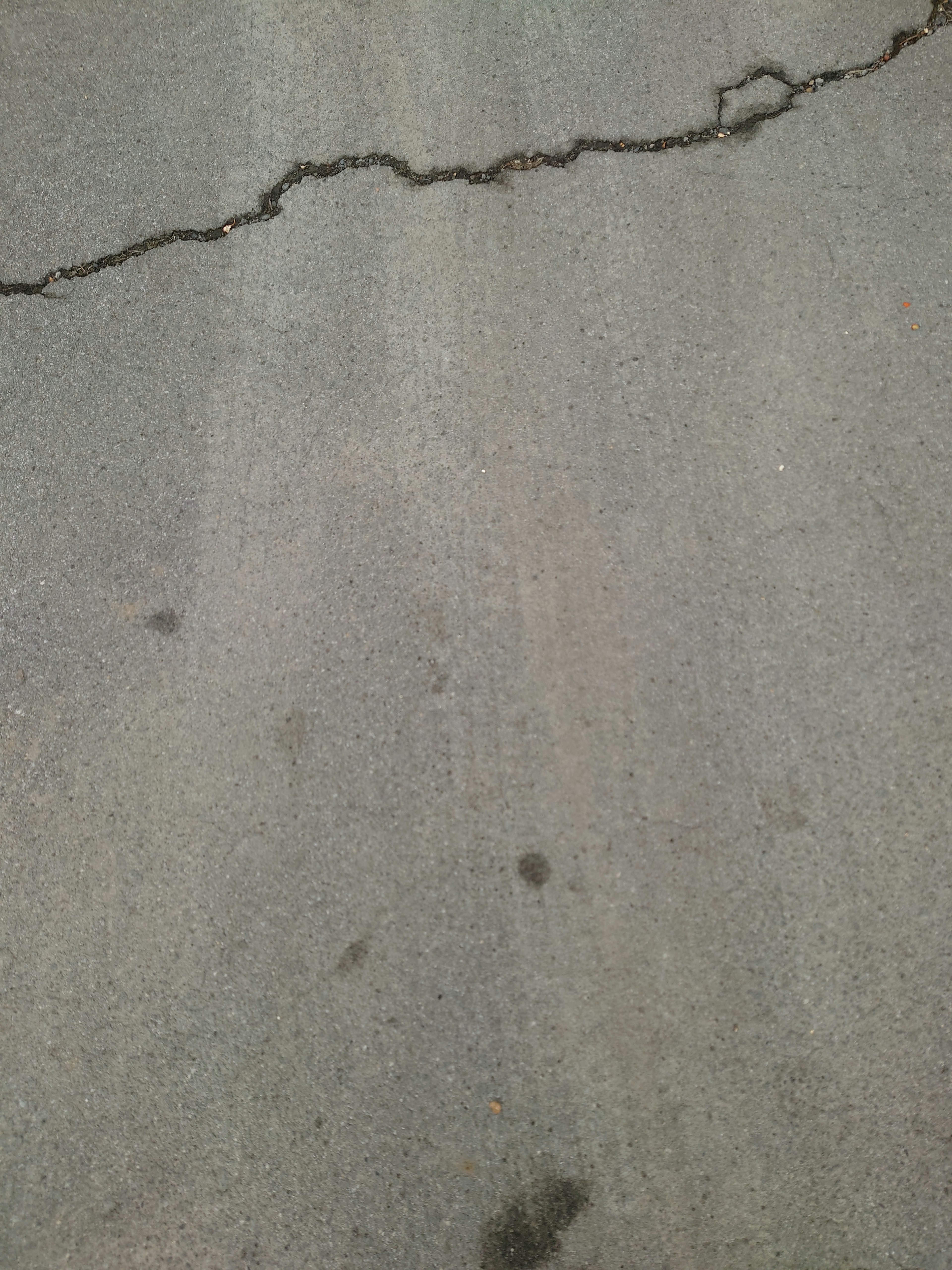 Image of a cracked gray concrete surface