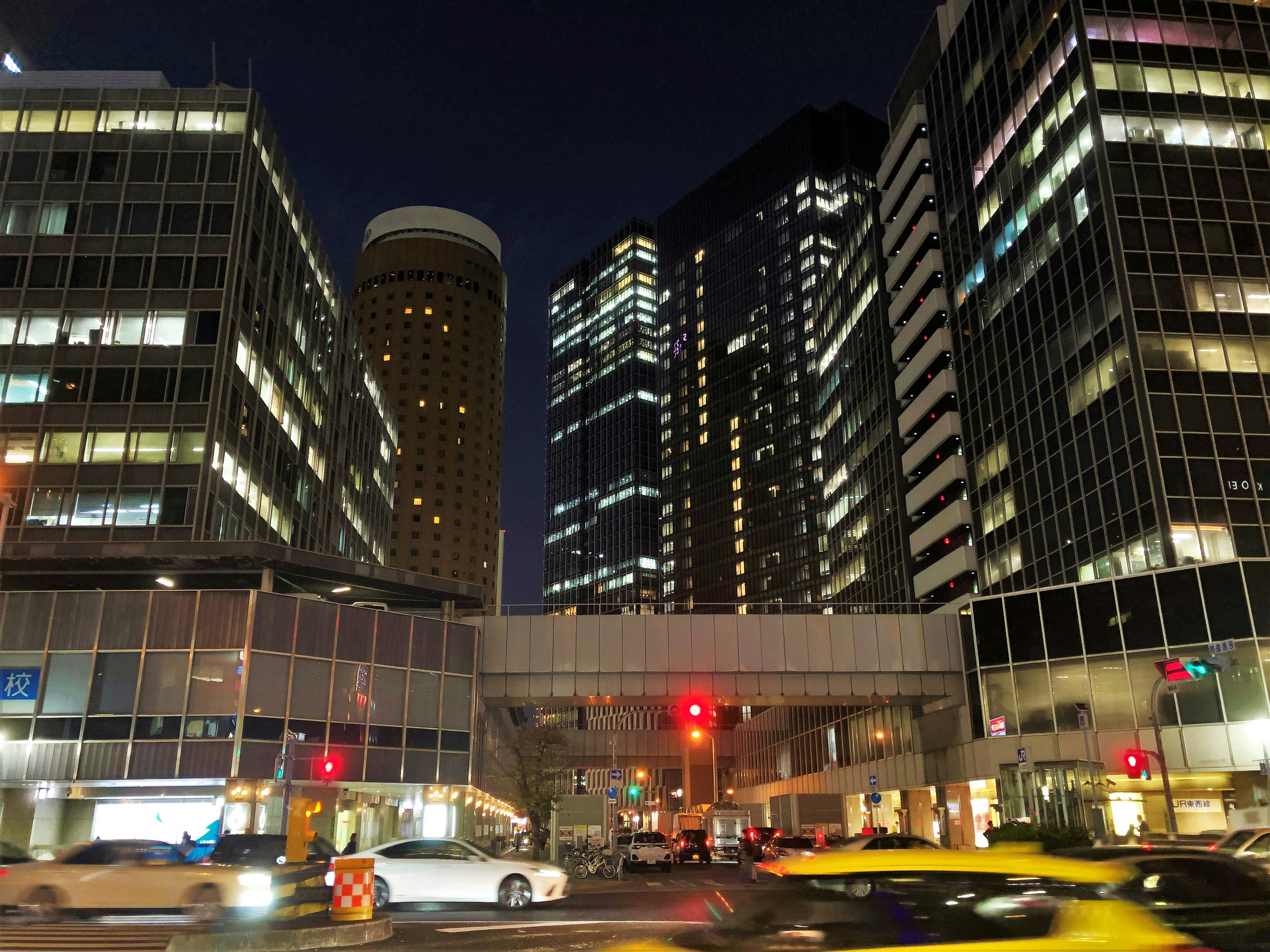 Night cityscape featuring illuminated skyscrapers and a busy intersection